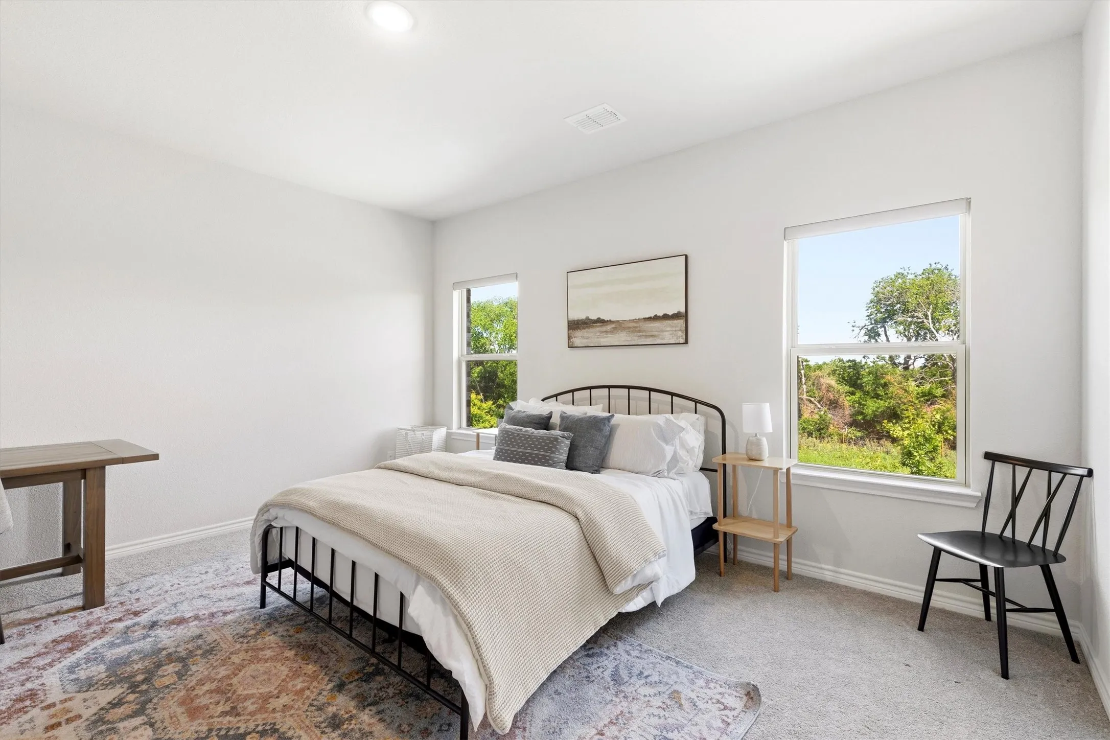 Bedroom featuring two windows, neutral carpeting, recessed ceiling lighting, and light-toned wall finishes