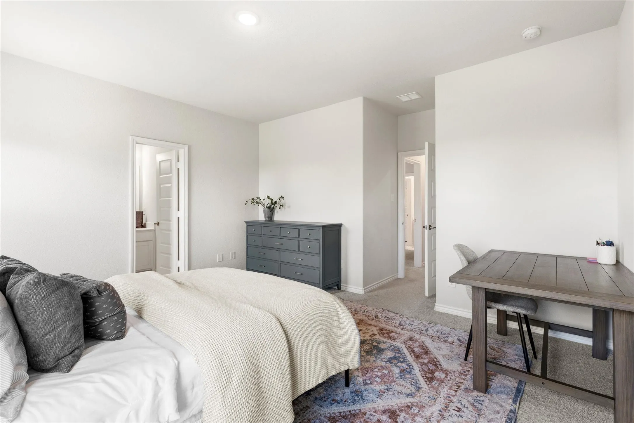 Neutral-toned bedroom with recessed lighting, carpeted flooring, and white trim