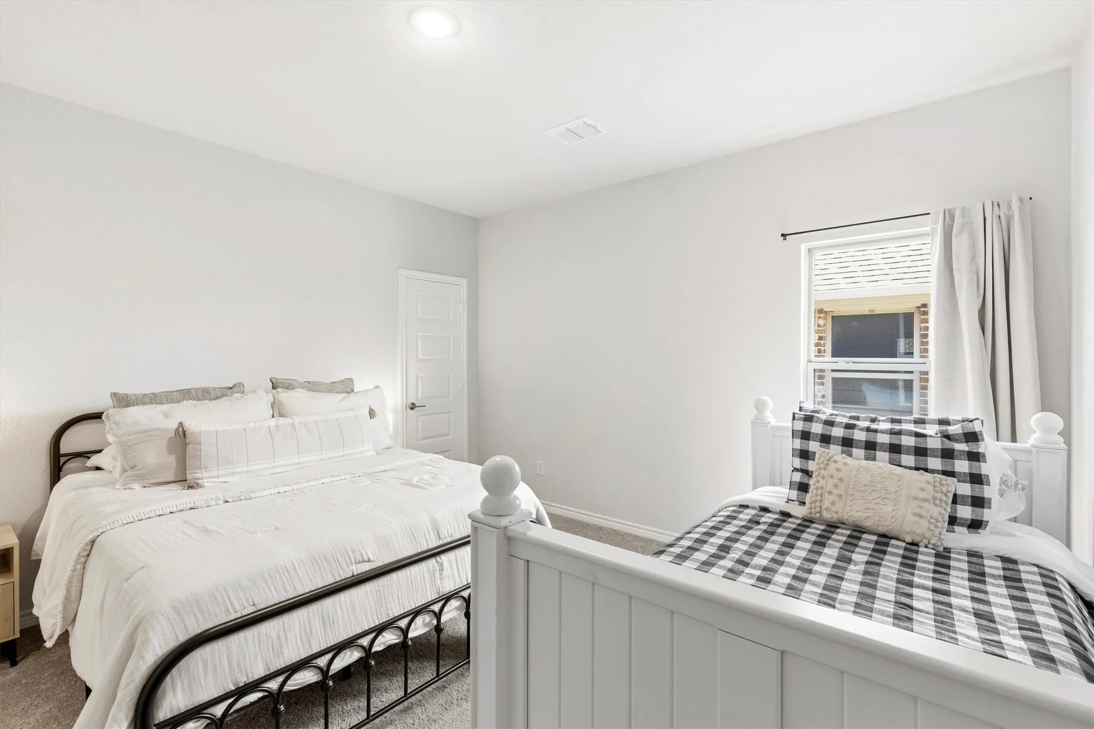 Neutral-toned interior with light gray walls, recessed lighting, and gray carpeting