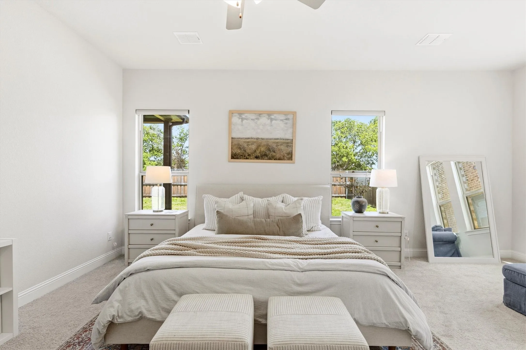 Spacious room featuring light-colored carpeting and white walls