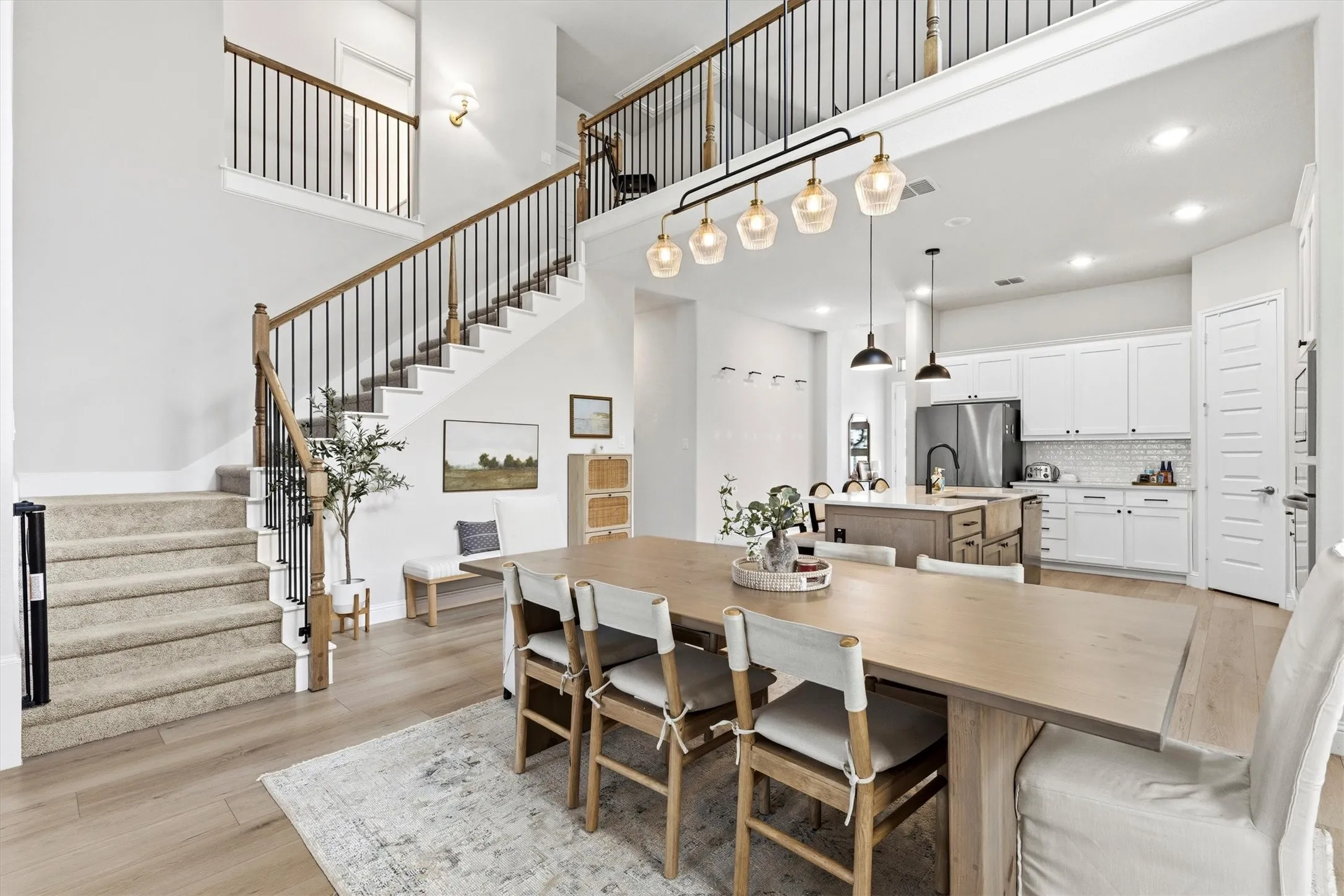 Open-concept main living area featuring high ceilings and wood-finish flooring