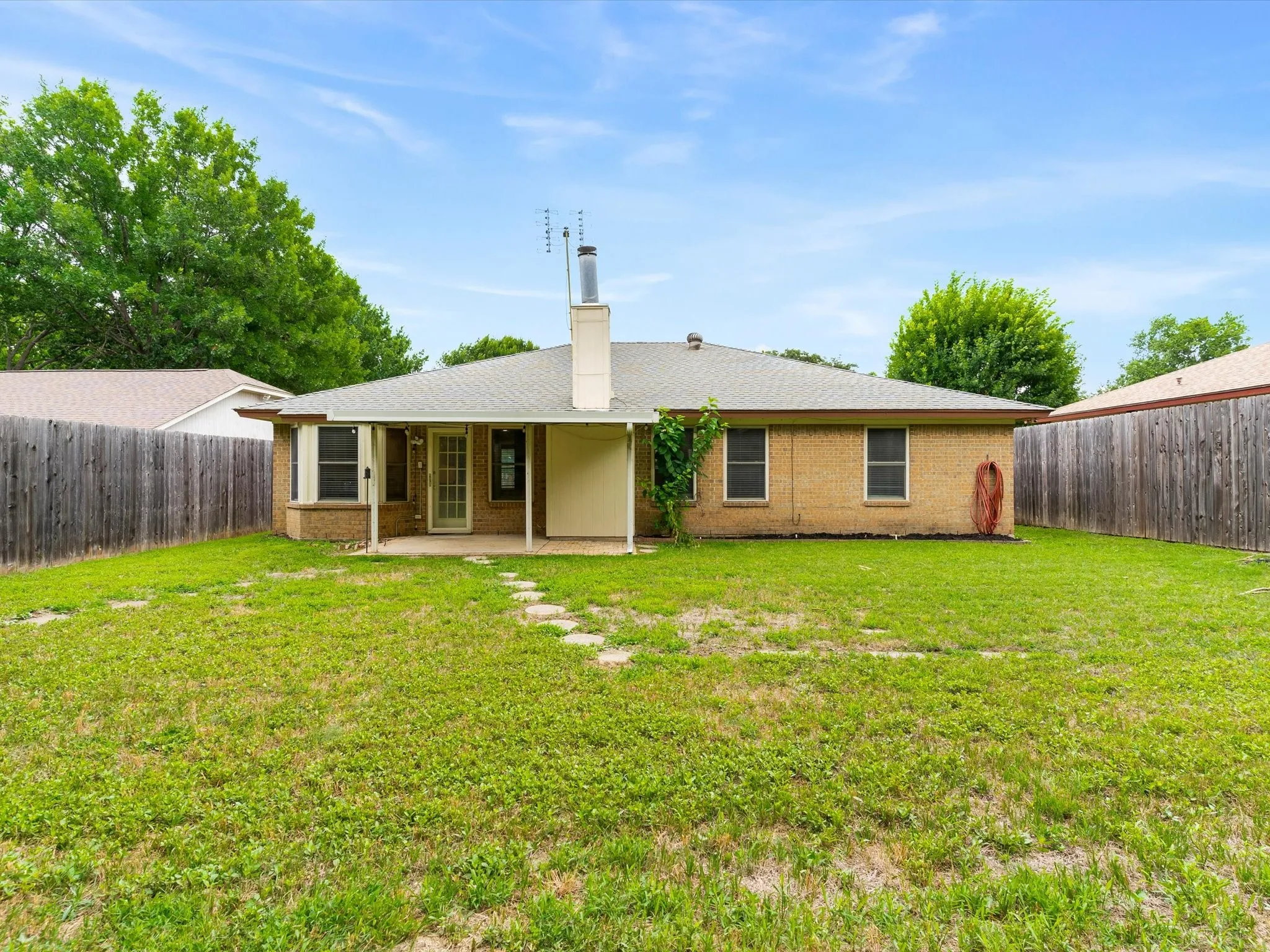 Backyard with open green space and room for pets, play, or gardening.