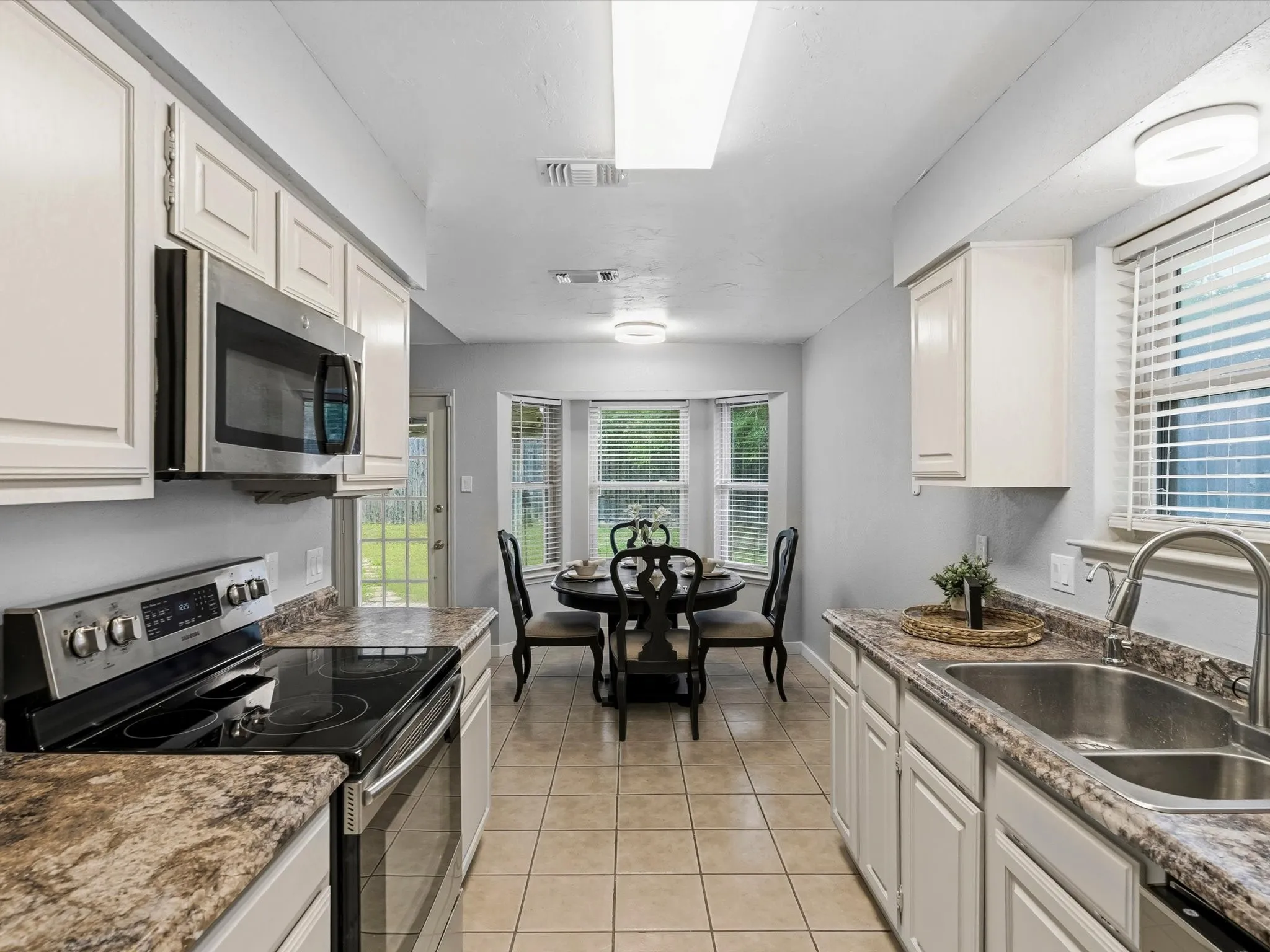 Kitchen featuring ample cabinet storage, generous counter space, and easy access to dining area.