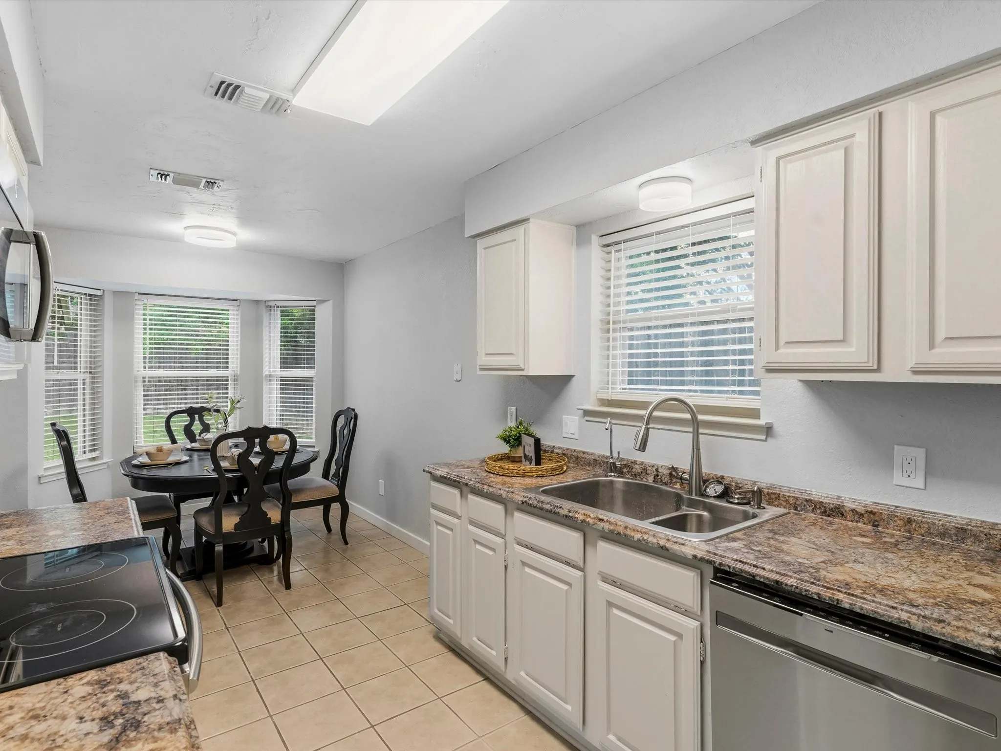 Kitchen featuring ample cabinet storage, generous counter space, and easy access to dining area.