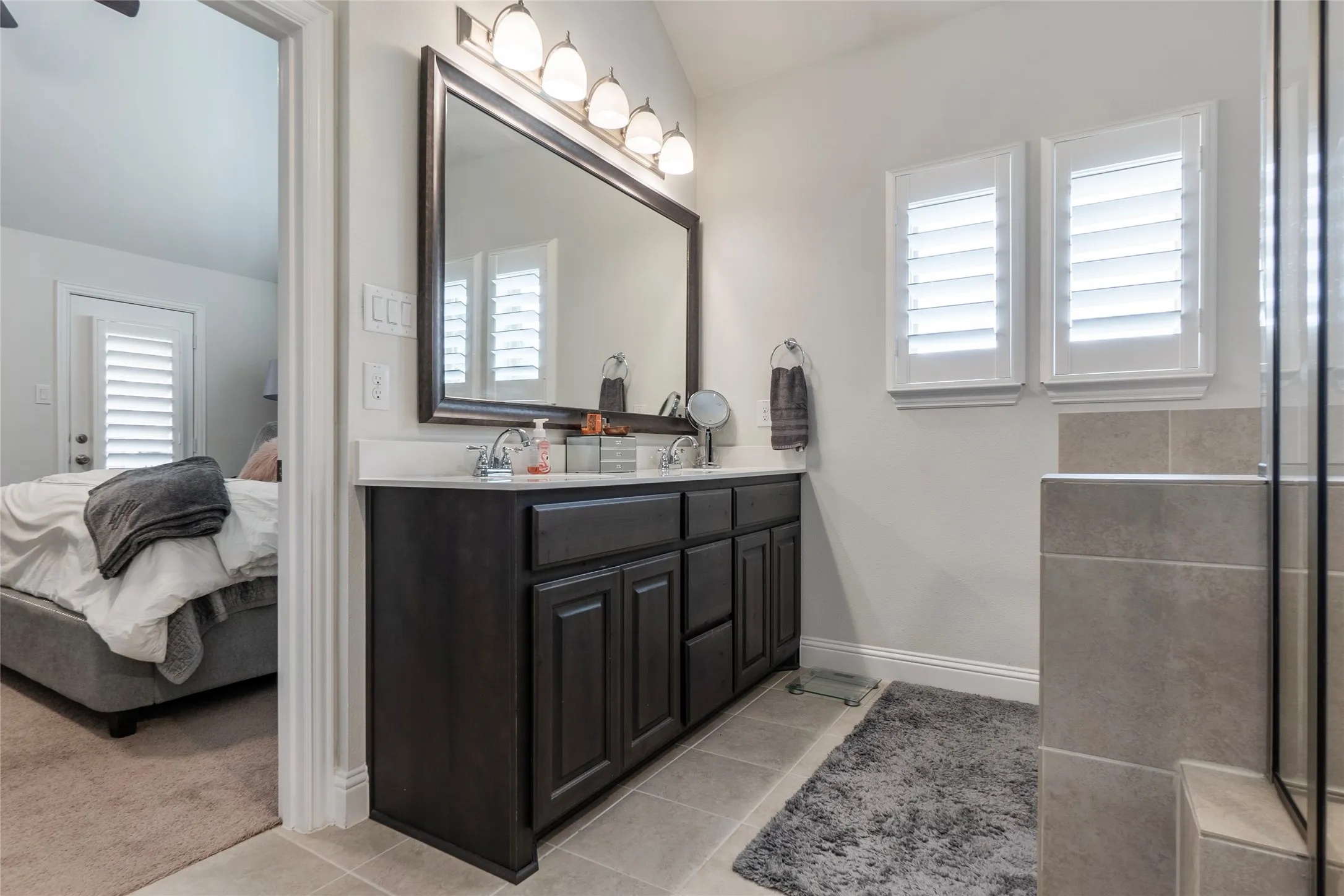 Double vanity with tons of natural light; Modern plantation shutters