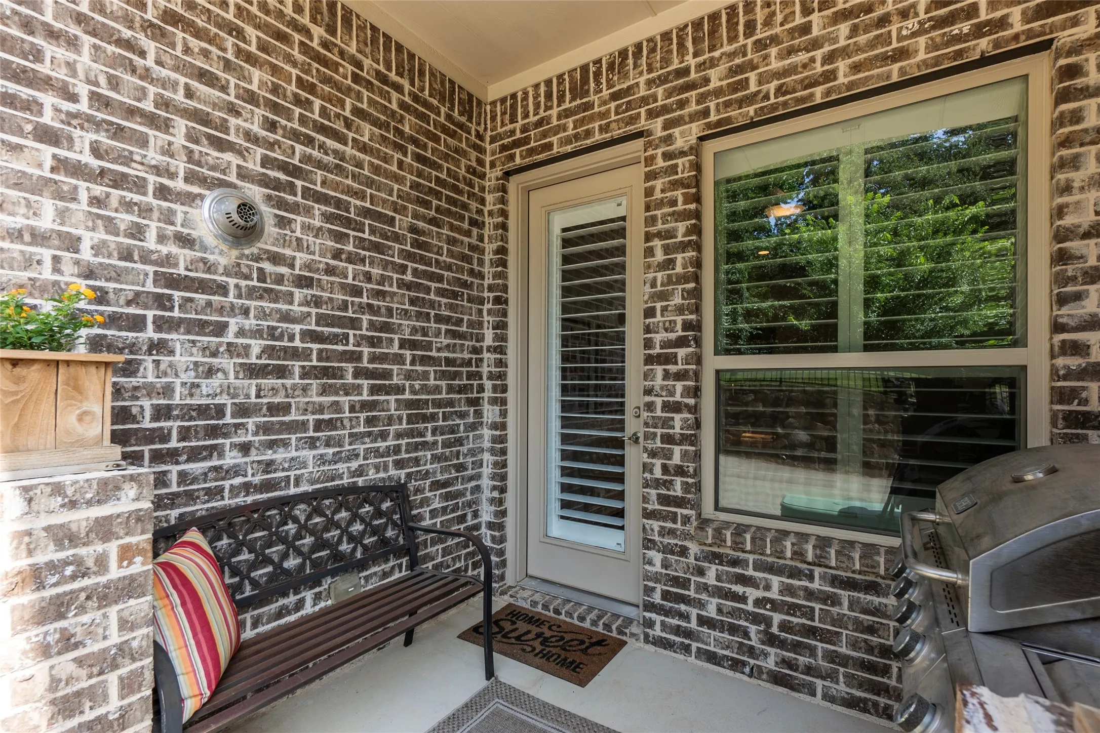 Back patio space for seating and grilling with tree view