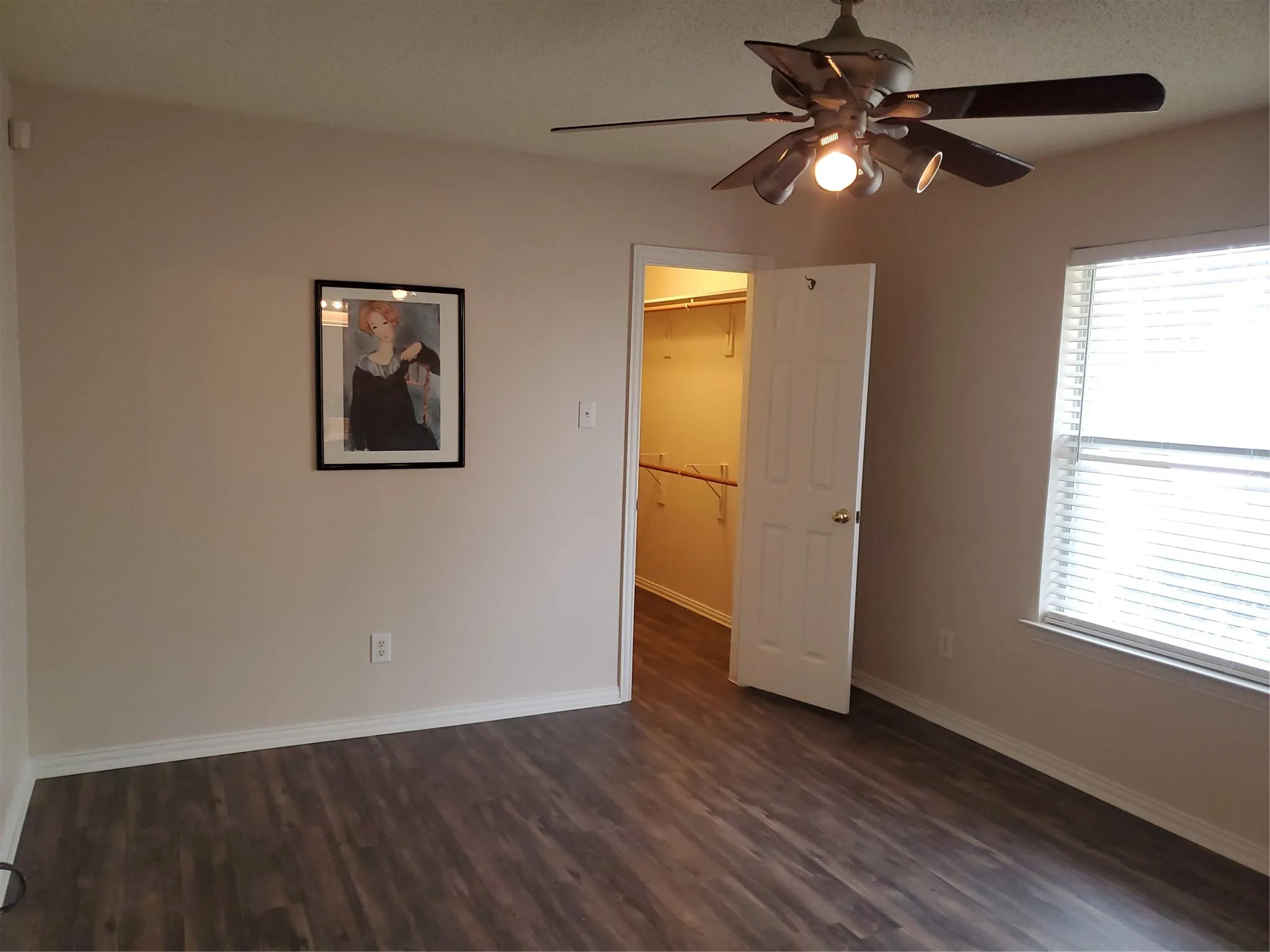 Primary bedroom in the back with ceiling fan.