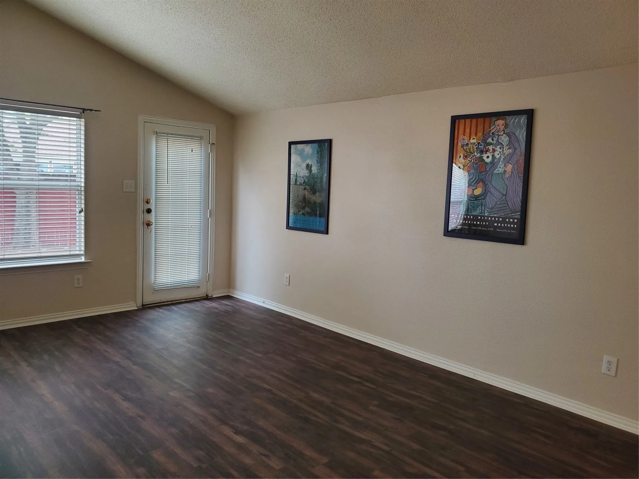View of family room with vaulted ceiling and walls of windows.