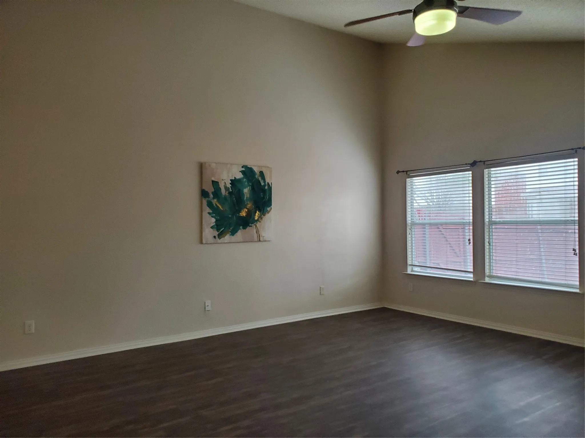2nd View of family room with ceiling fan with remote control and new laminate flooring.