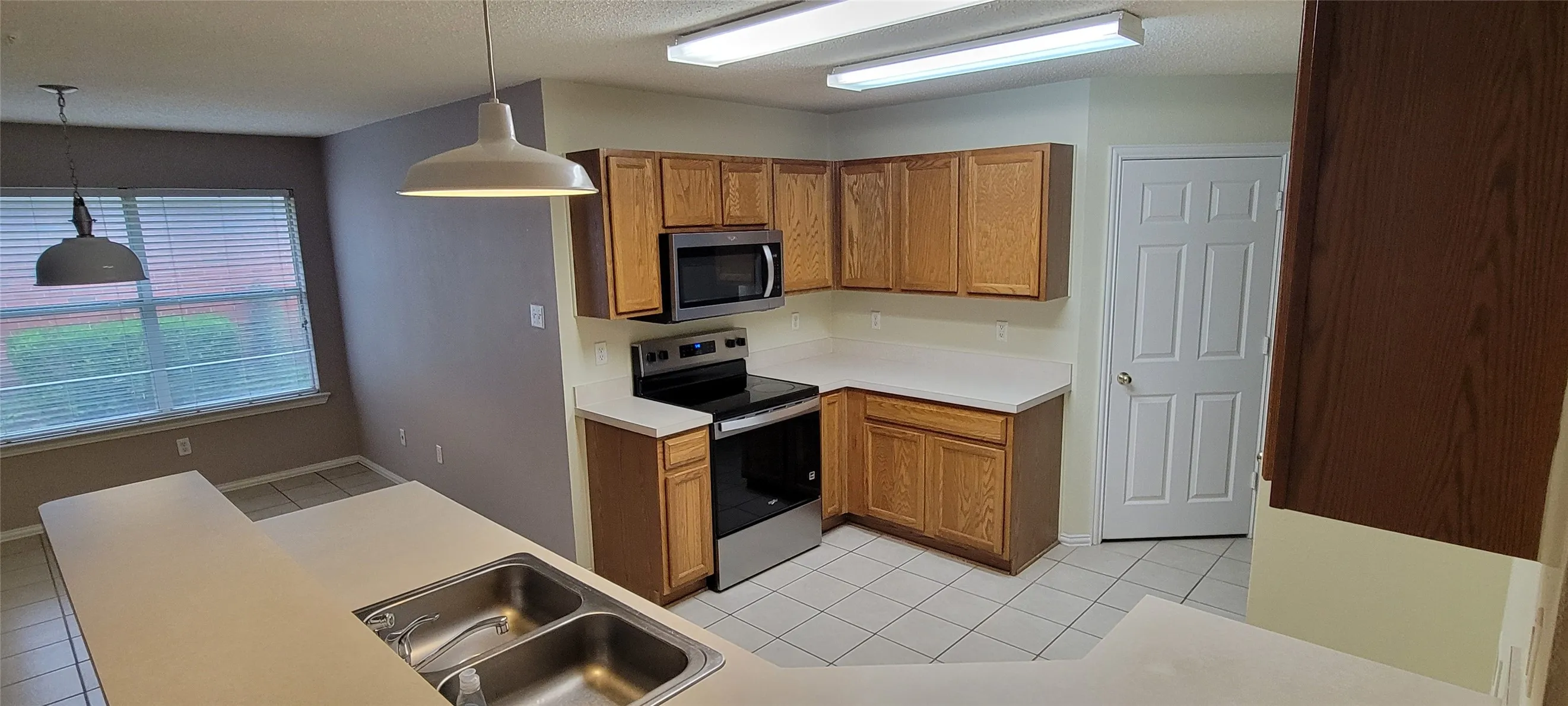 Tiled floor in Kitchen, breakfast area. Well kept cabinets & appliances.  Both microwave and oven have been replaced recently