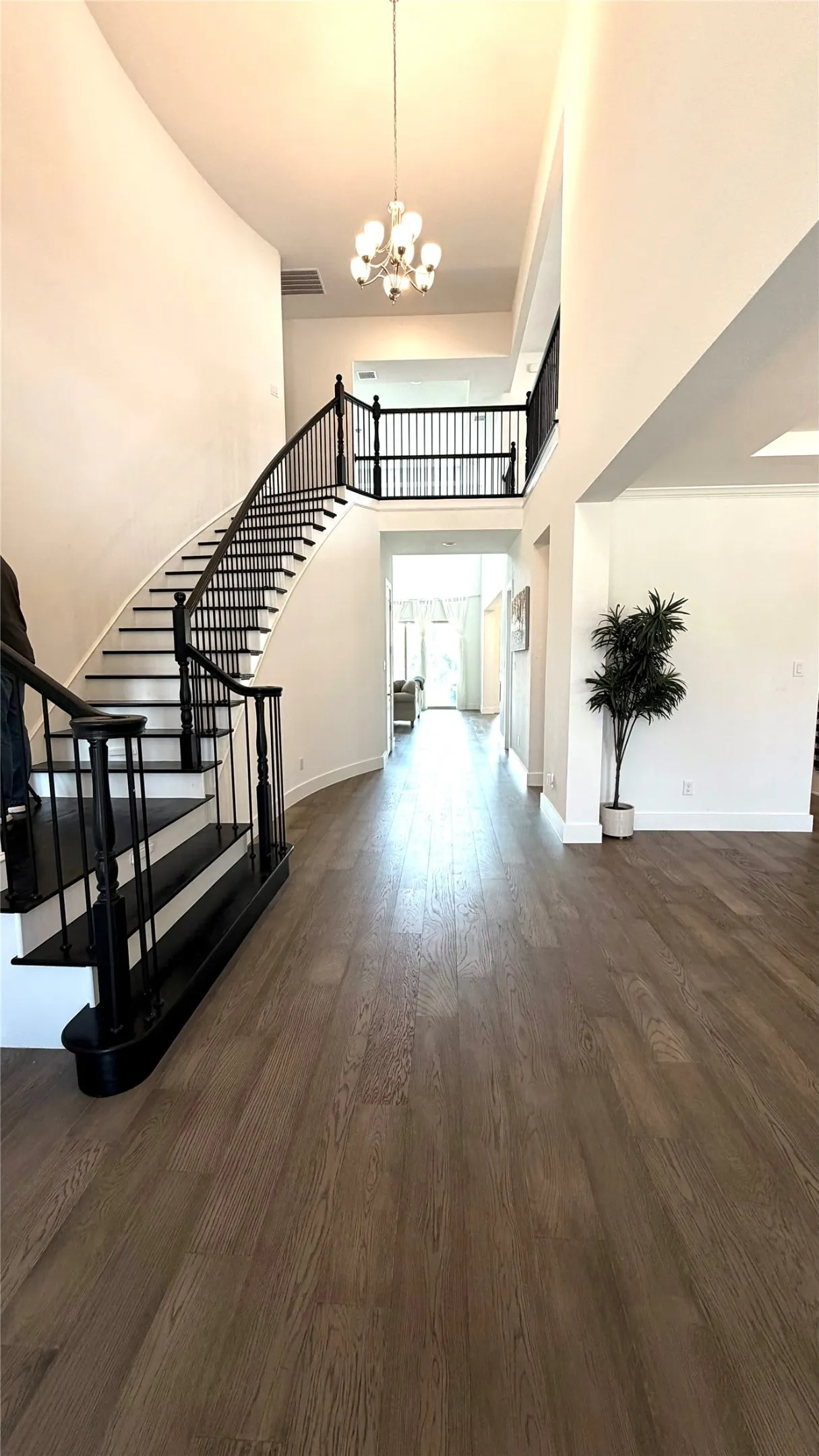 Foyer, Hallway and wooden stairs with wrought iron rails