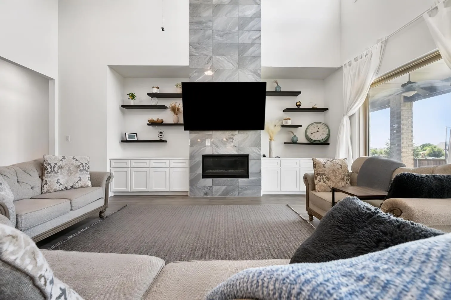 Large family room with custom cabinets and built in shelves