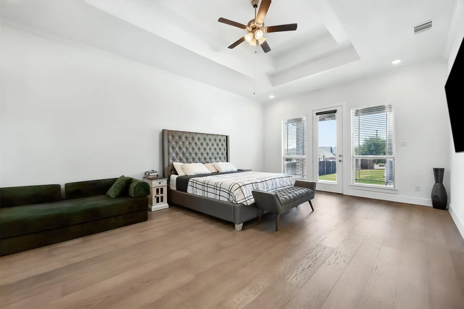 Primary bedroom with vaulted ceilings and easy excess to the extended patio