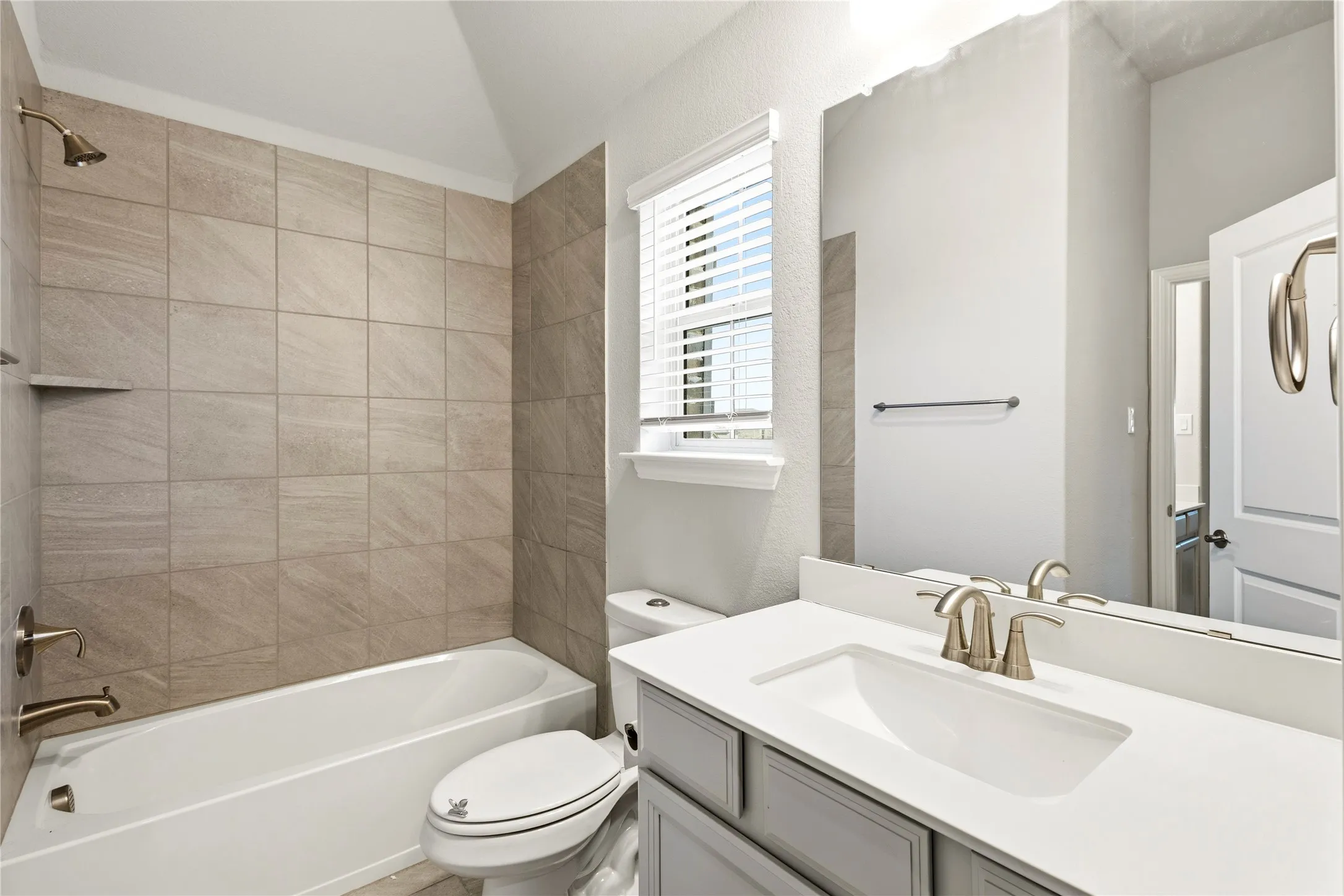 Bathroom vanity with an integrated sink and brushed nickel faucet