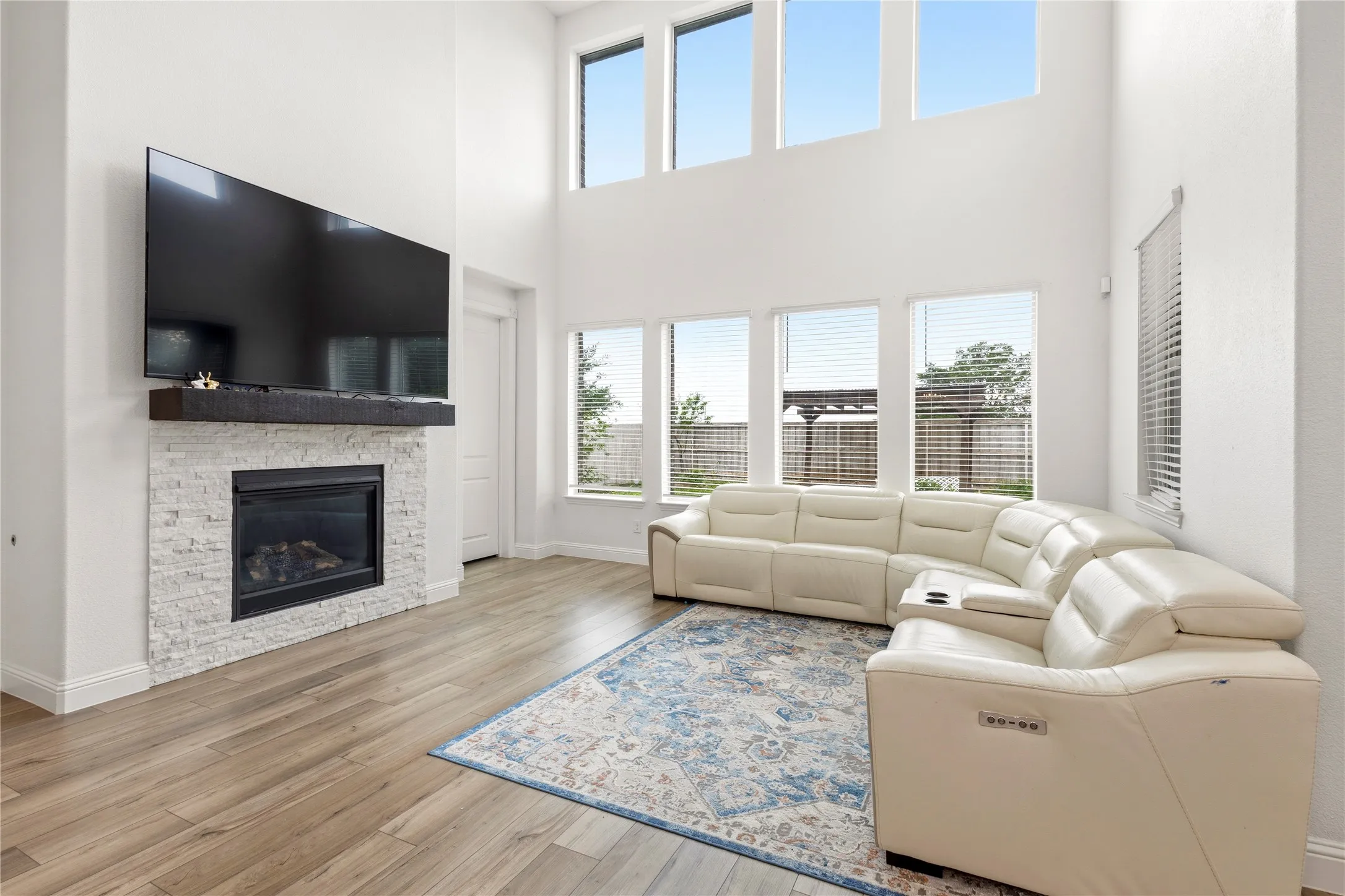 Living area with high ceilings and wood-finish flooring