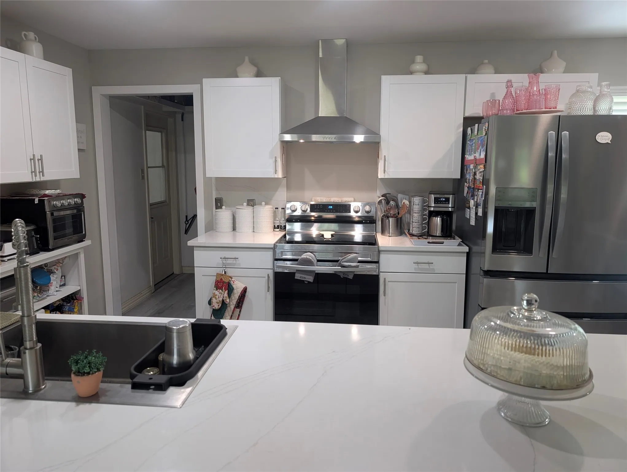 Lovely kitchen with stainless steel appliances and granite counters and back splash.