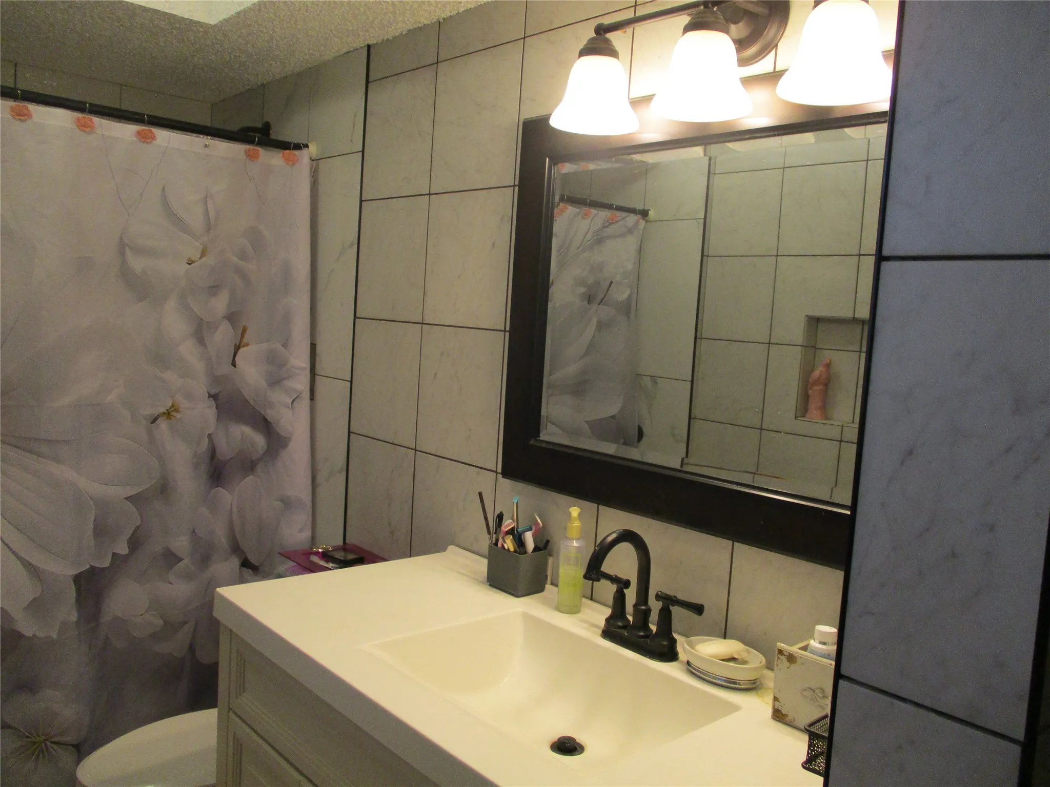 Step-in shower, tall vanity and shelves for linen