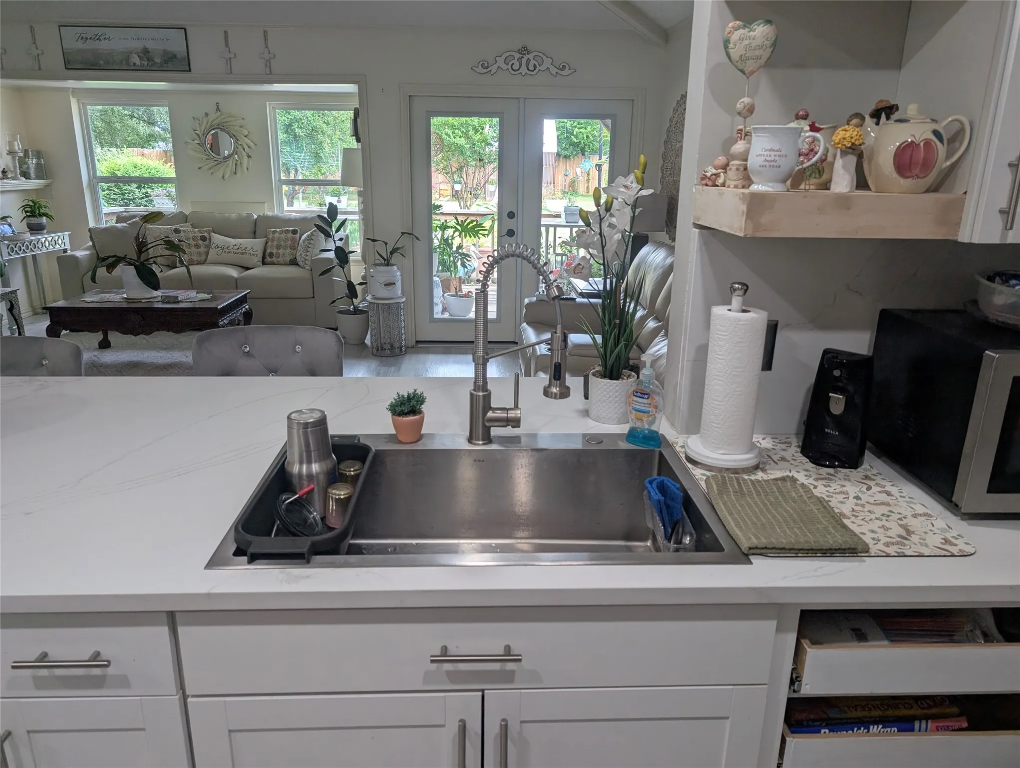 Kitchen opens to the living space that is full of light.
