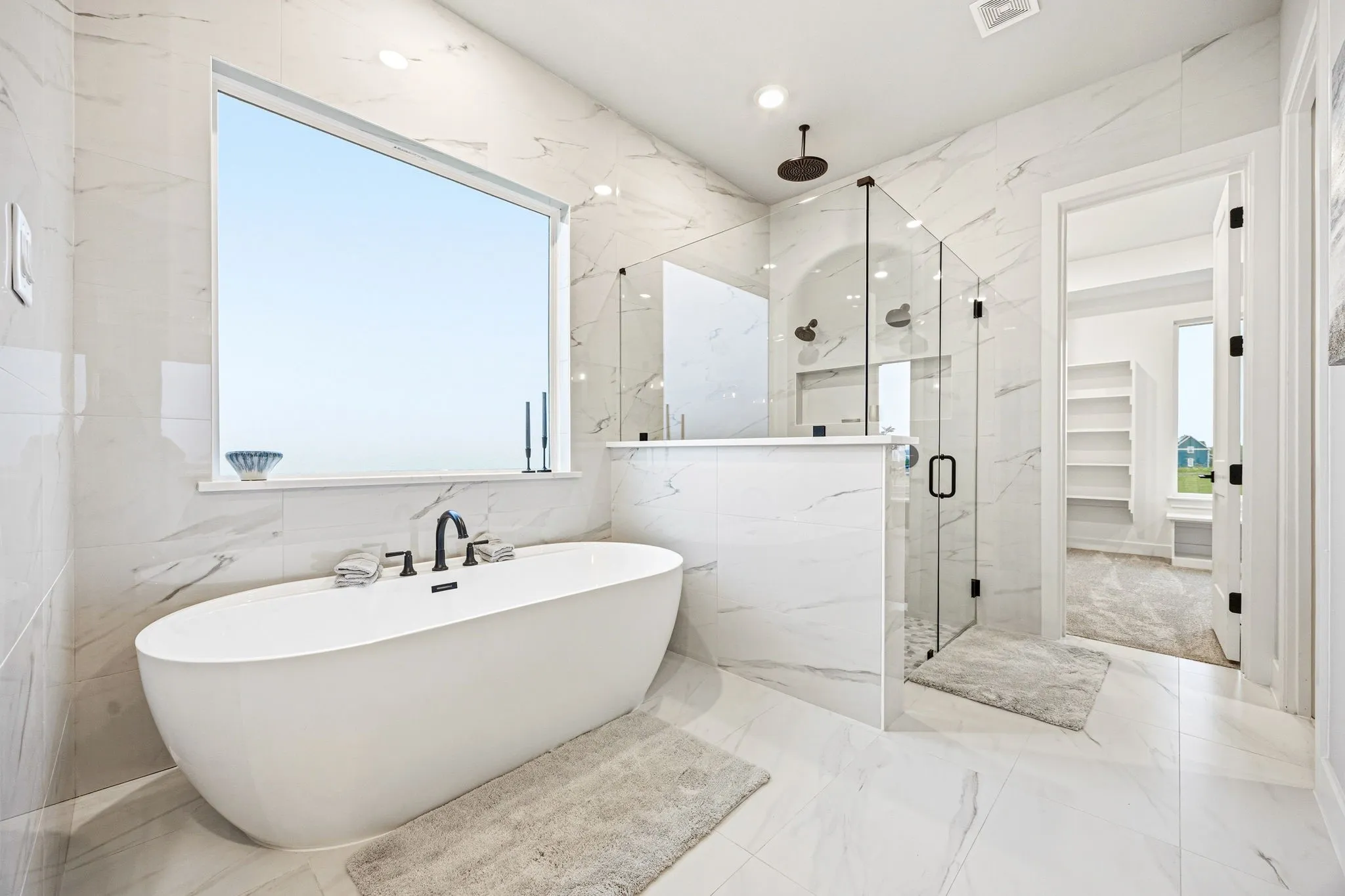 Freestanding soaking tub with a floor-to-ceiling window
