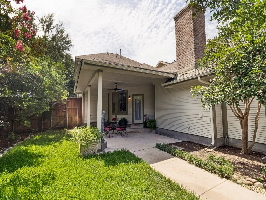 covered patio overlooks side yard