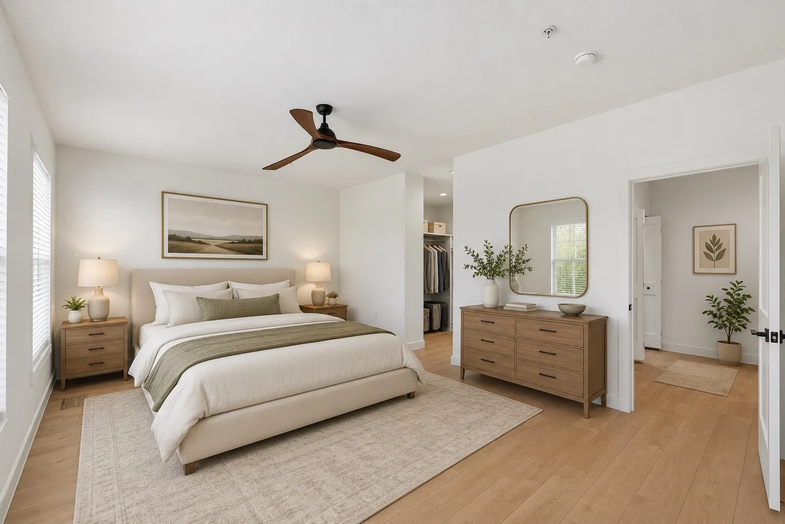 Bedroom featuring light wood-finish flooring and a ceiling fan with wood-tone blades