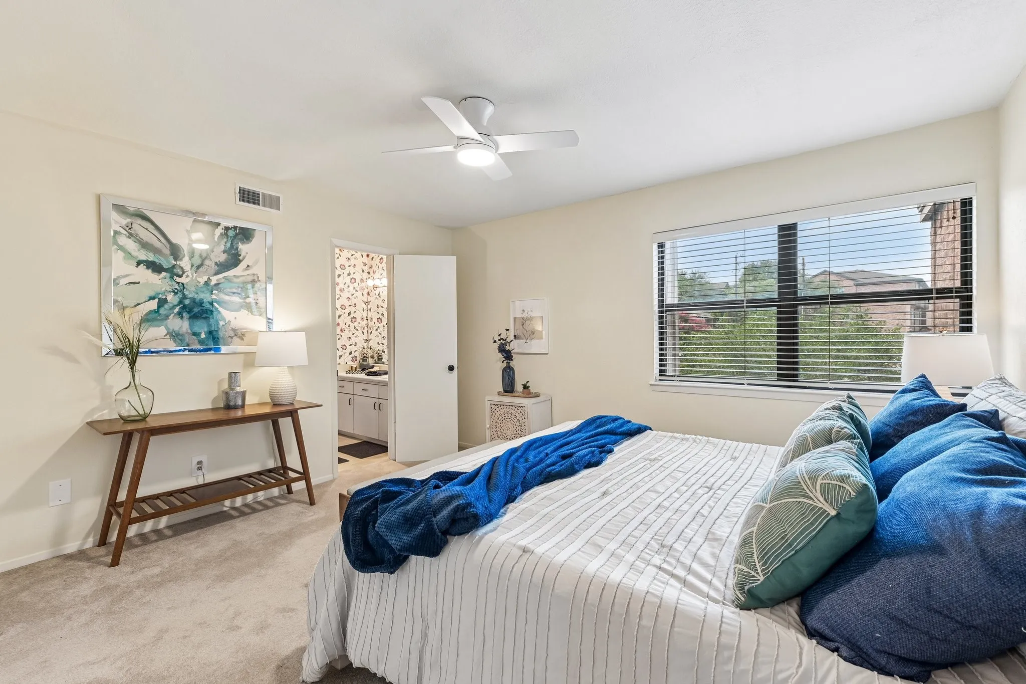 Spacious Primary Bedroom, staged with a King sized bed, has a walk-in closet and an ensuite bathroom