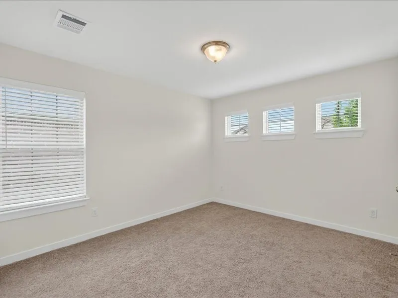 Neutral-toned carpeting paired with light-colored walls