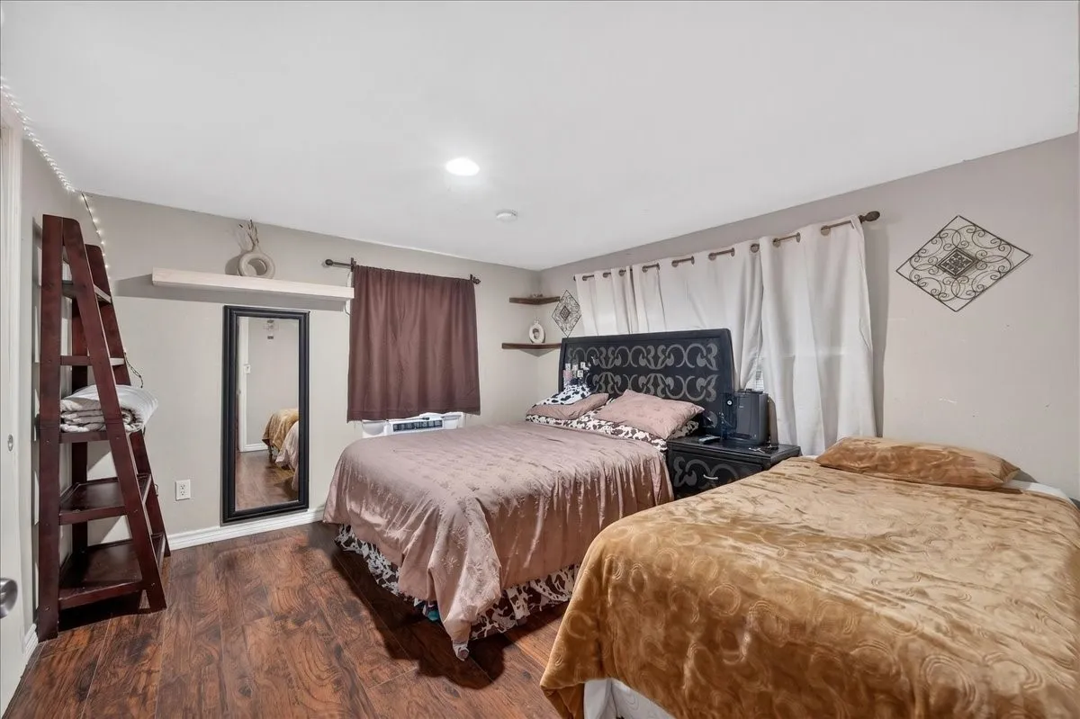 Room featuring wood-finish flooring and neutral wall tones