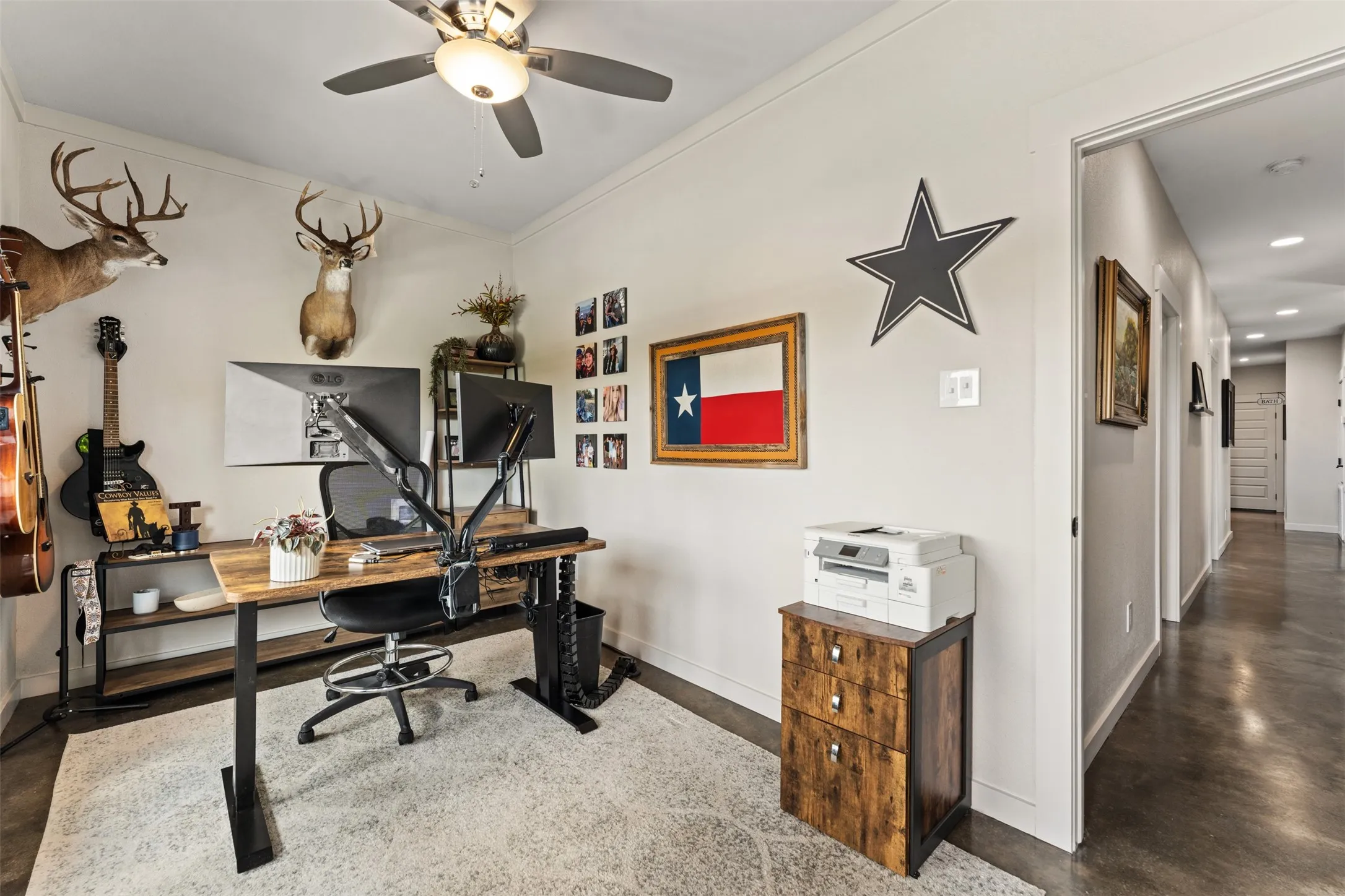 Dedicated room featuring a ceiling fan, light-toned walls, and a light-colored area rug