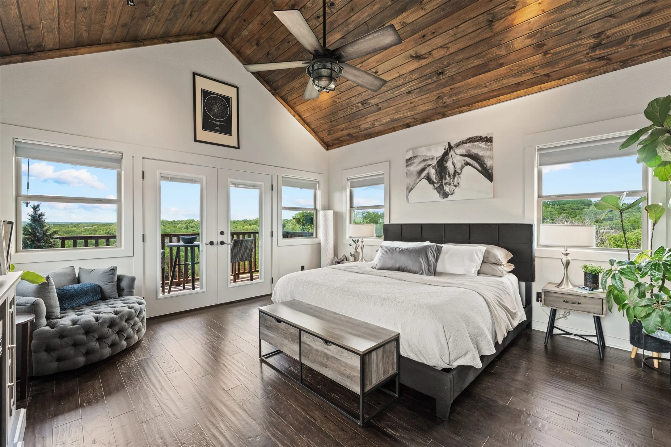Vaulted wood-plank ceiling with a ceiling fan, dark wood-finish flooring, and white walls