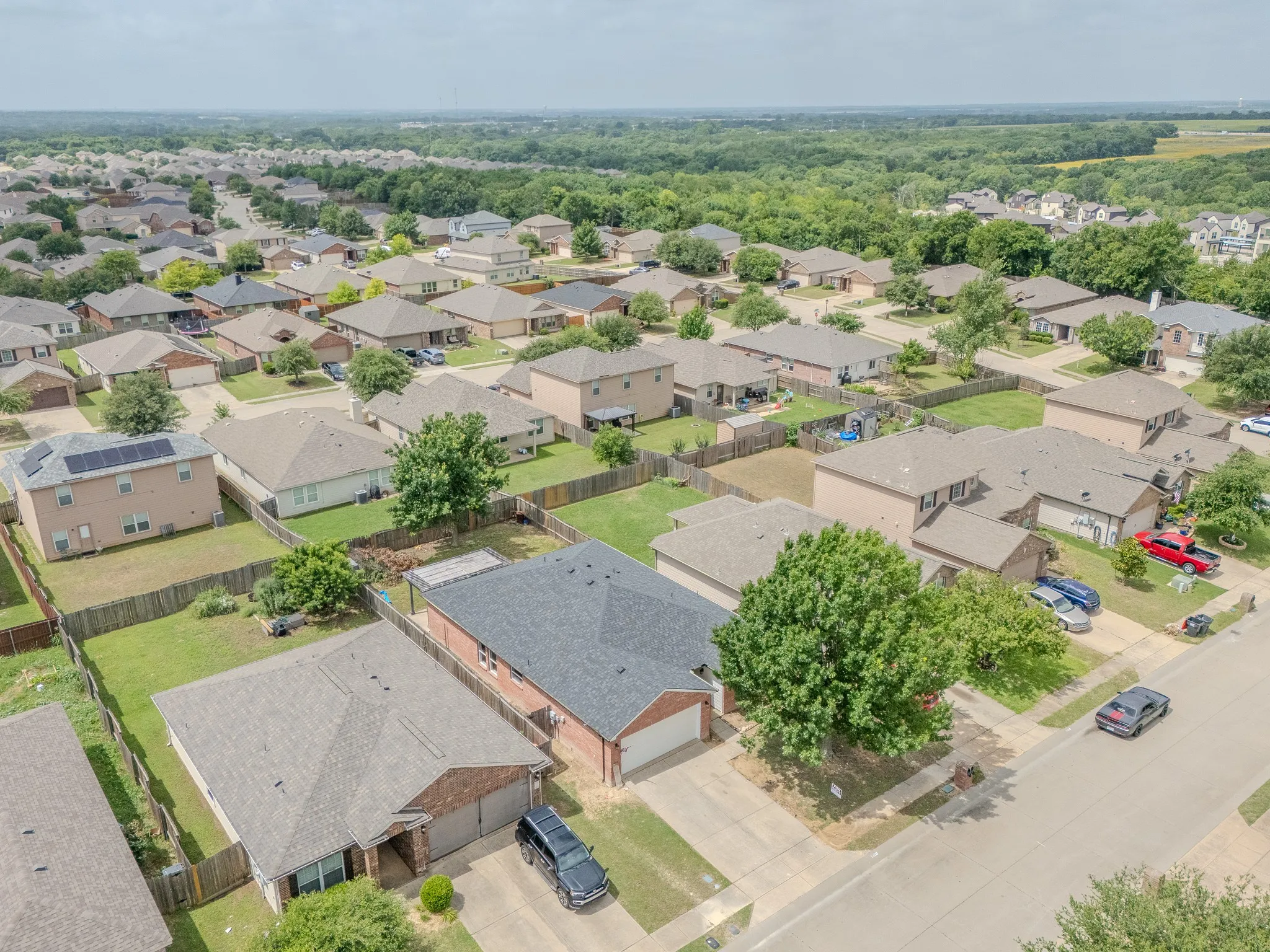 Aerial perspective showcasing a residential neighborhood with a mix of single and two-story homes