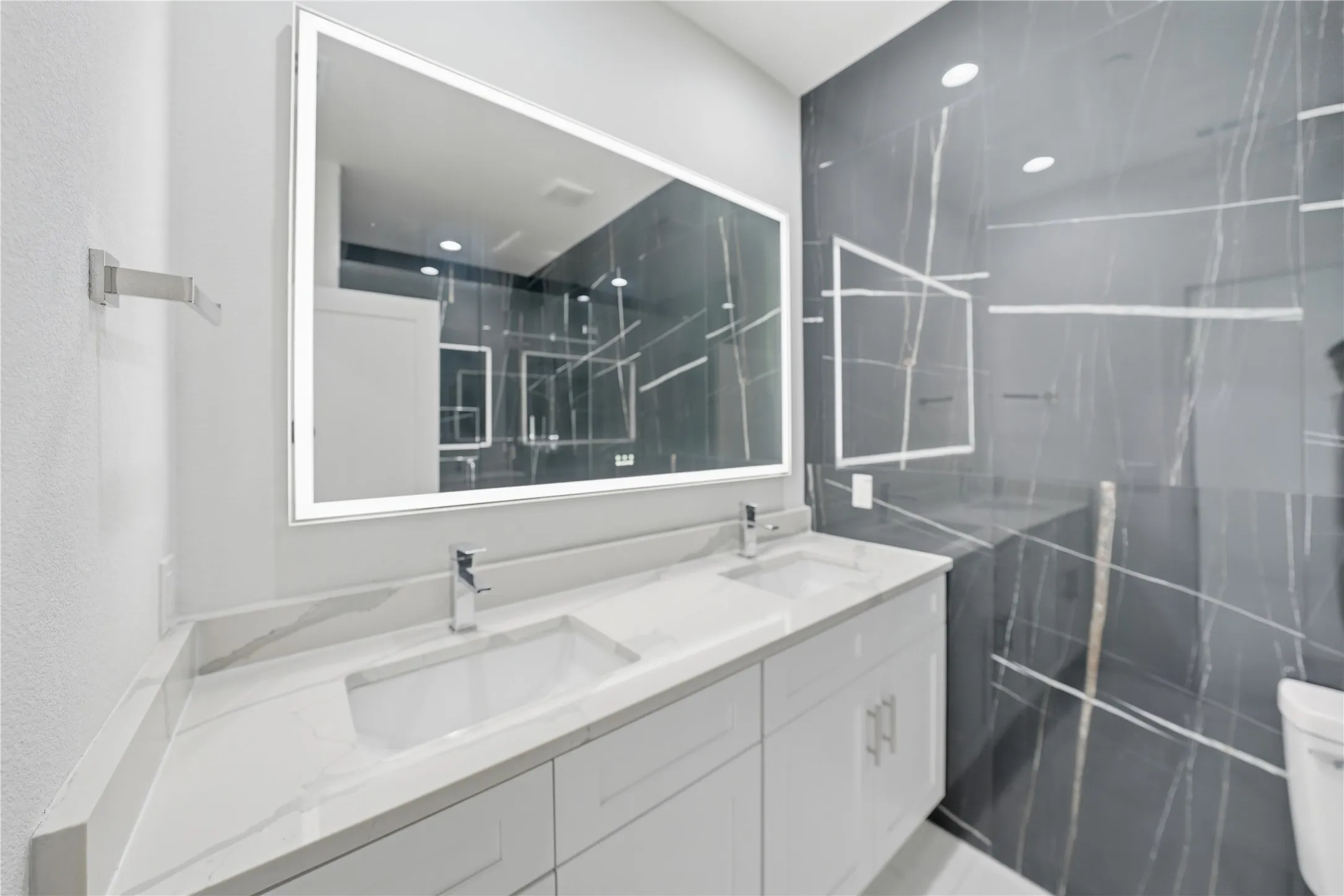 Dual vanity featuring integrated sinks and chrome faucets