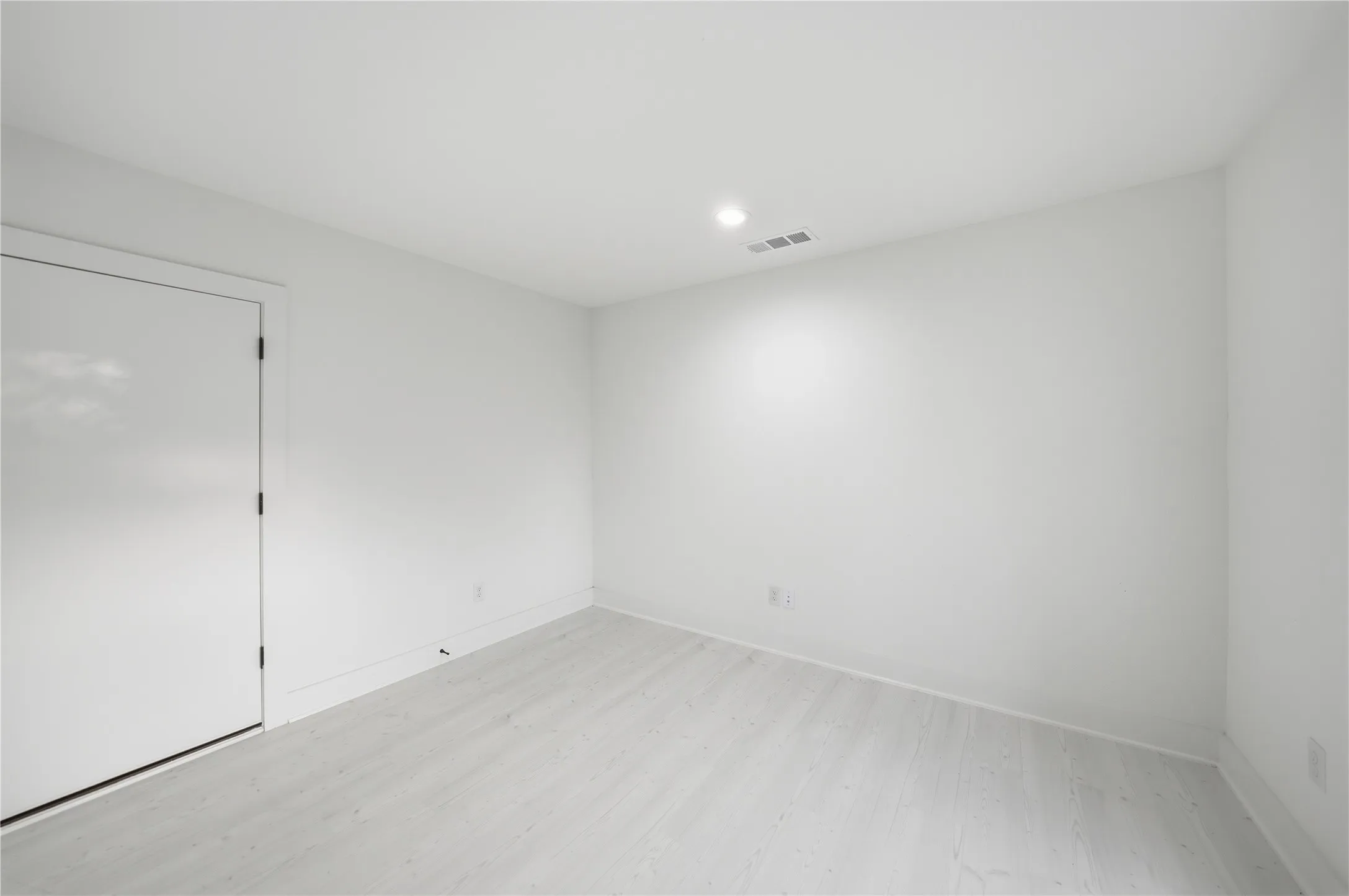 Bright interior space featuring light wood-finish flooring