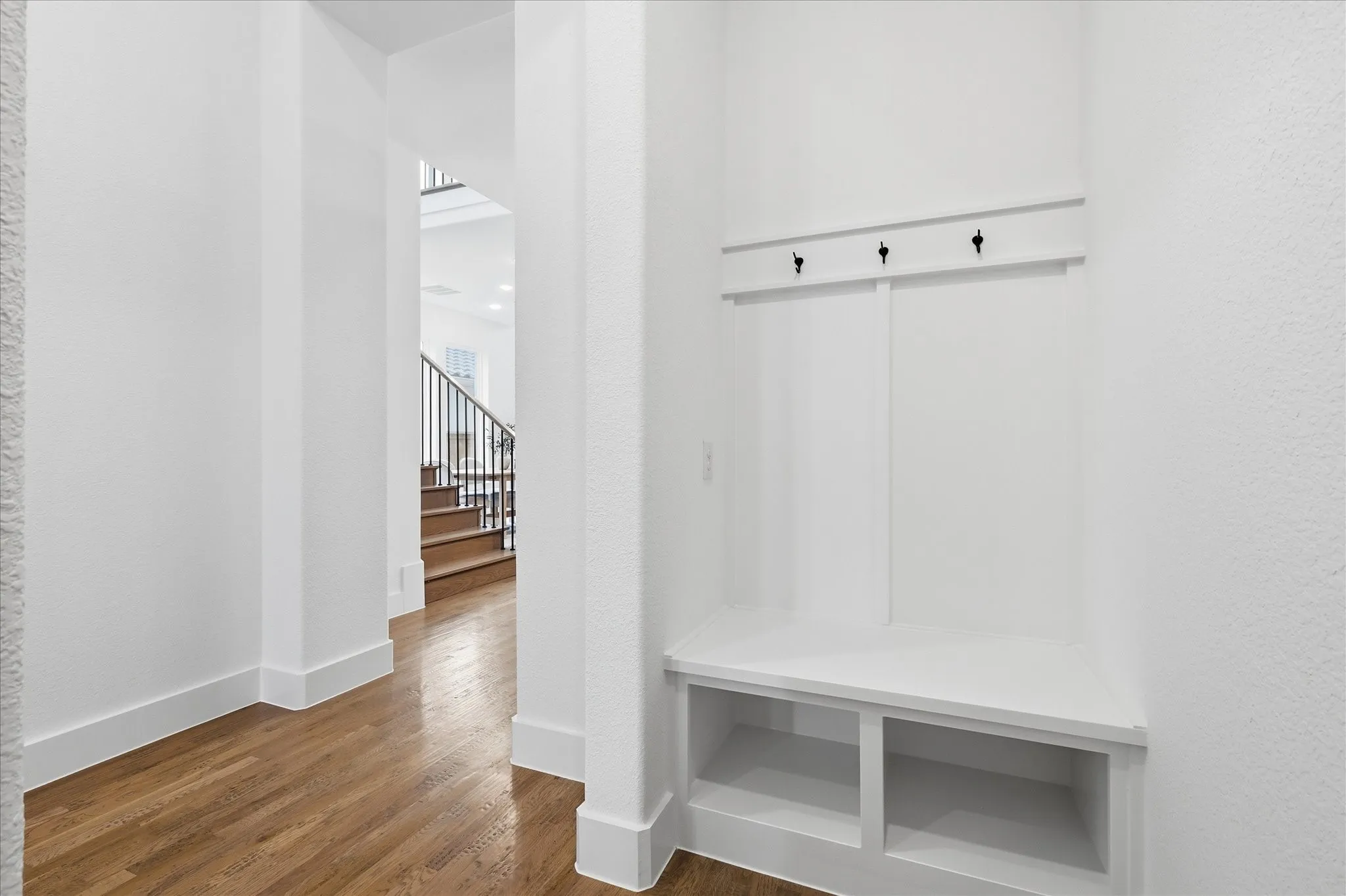 Built-in entryway bench with storage cubbies and coat hooks