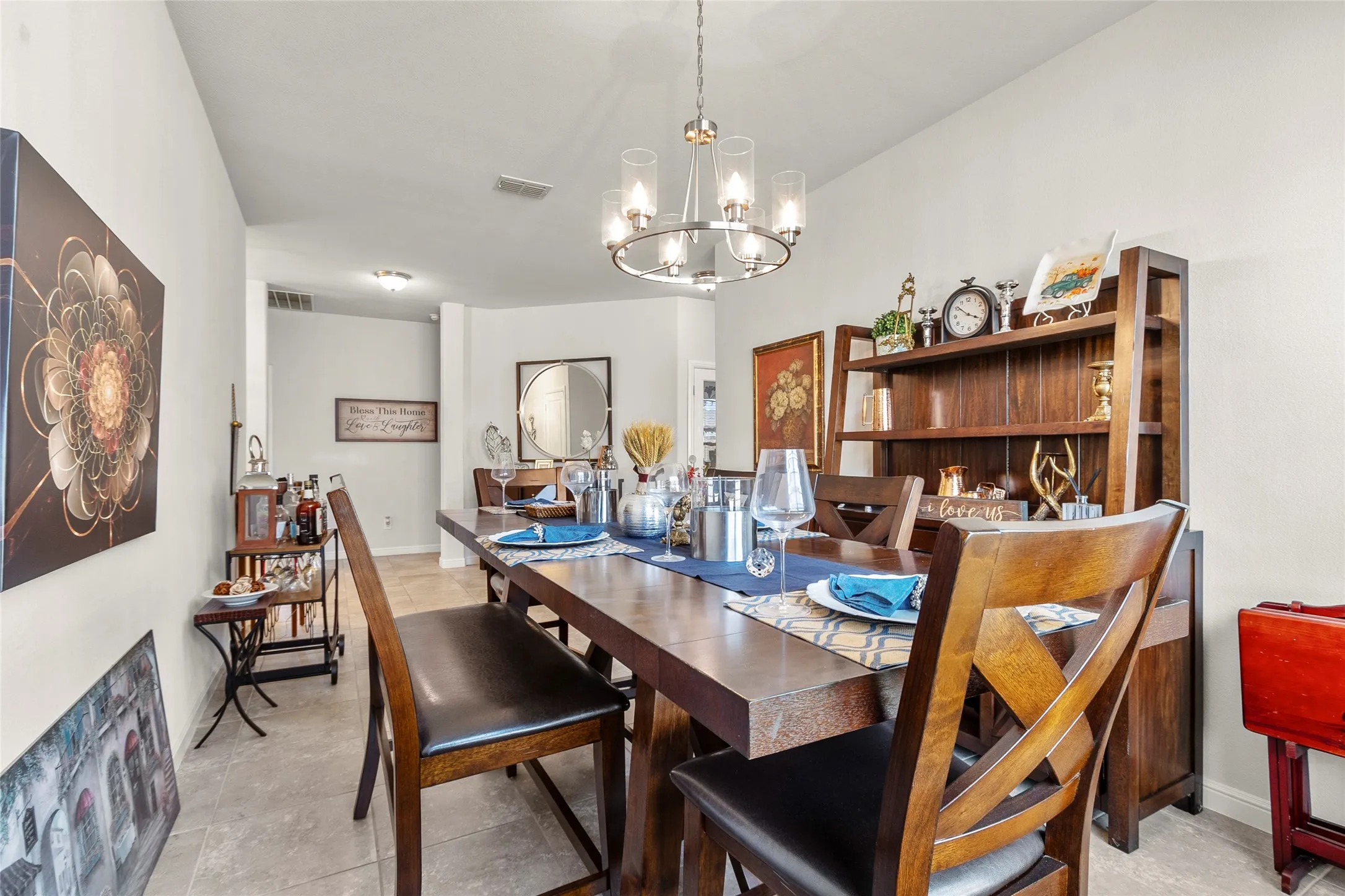 Dining area featuring neutral wall tones, tiled flooring, a modern chandelier, and recessed lighting