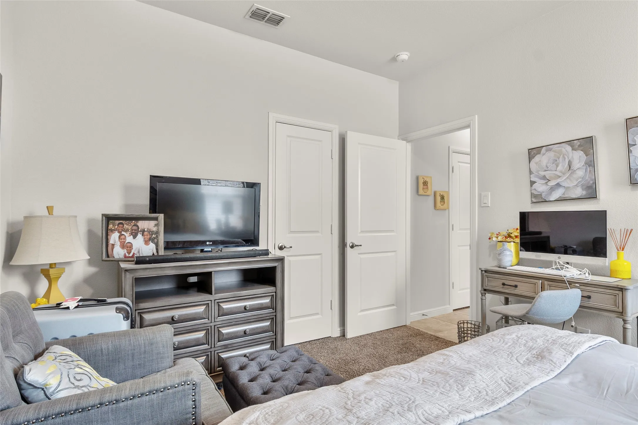 Light gray walls with white trim, two panel doors, and tan carpeting