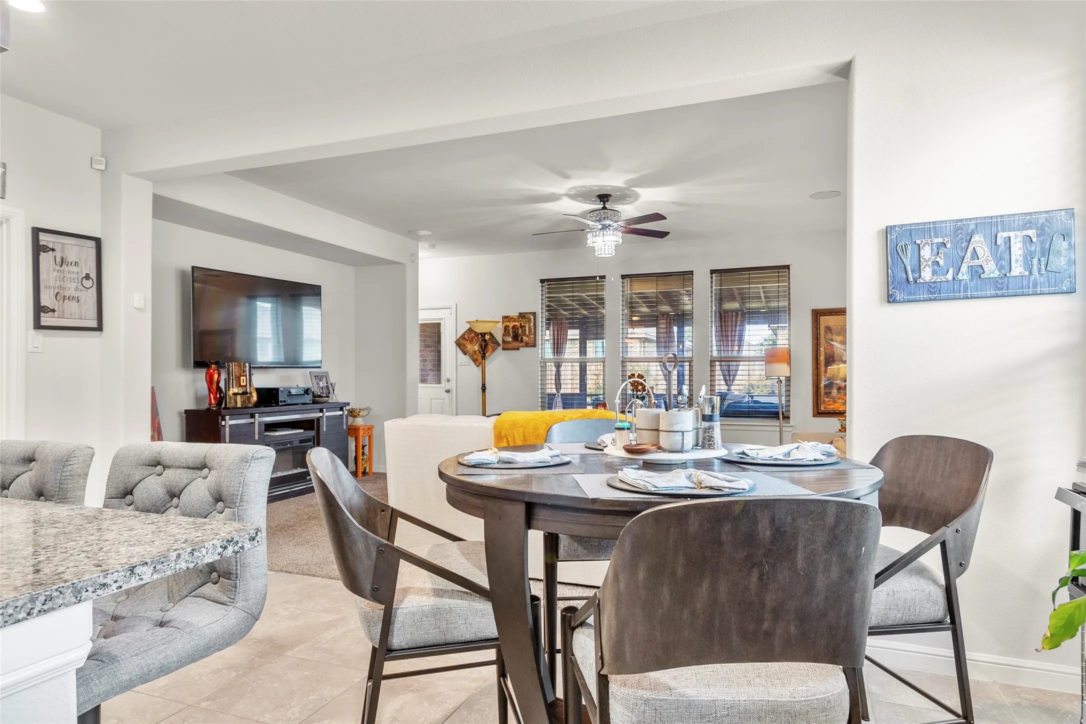 Open-concept interior featuring light-toned flooring, white walls, and recessed lighting