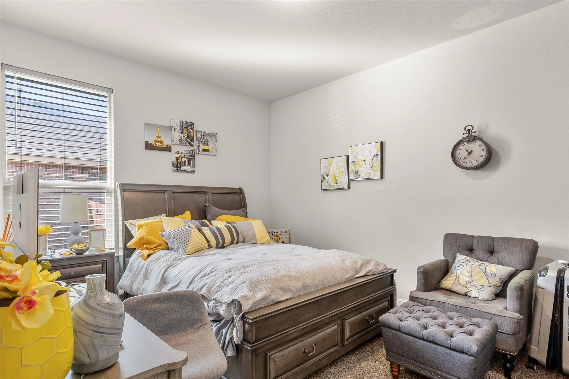 Bedroom featuring a window with horizontal blinds, light-colored walls, and neutral carpet flooring