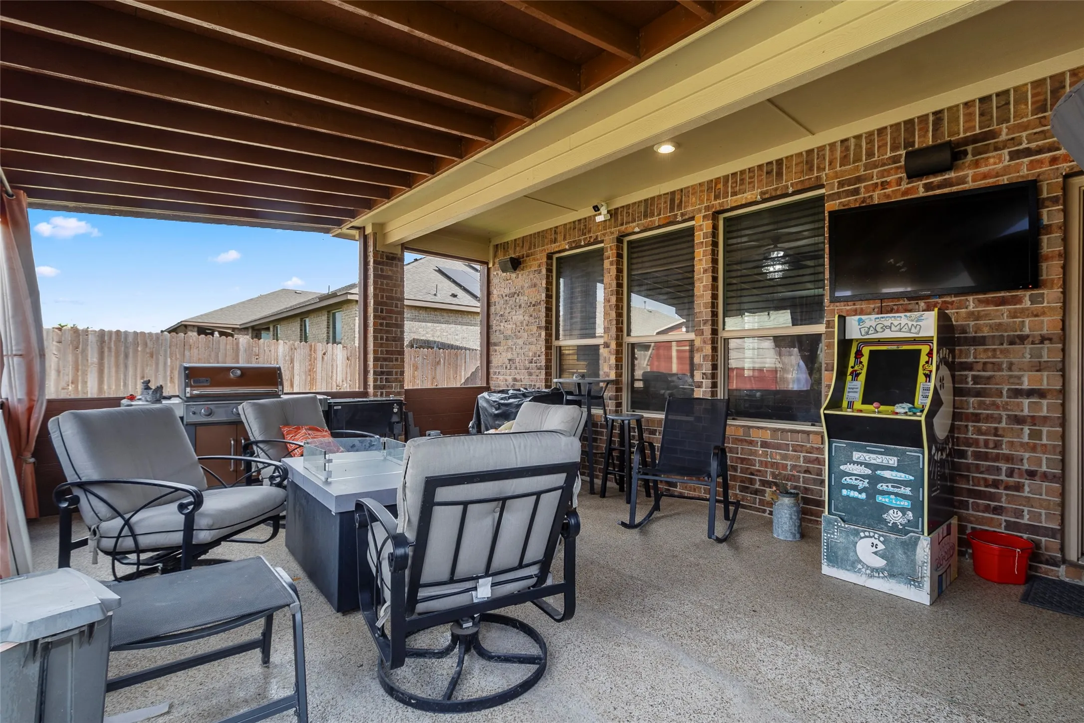 Covered outdoor patio with exposed beam ceiling
