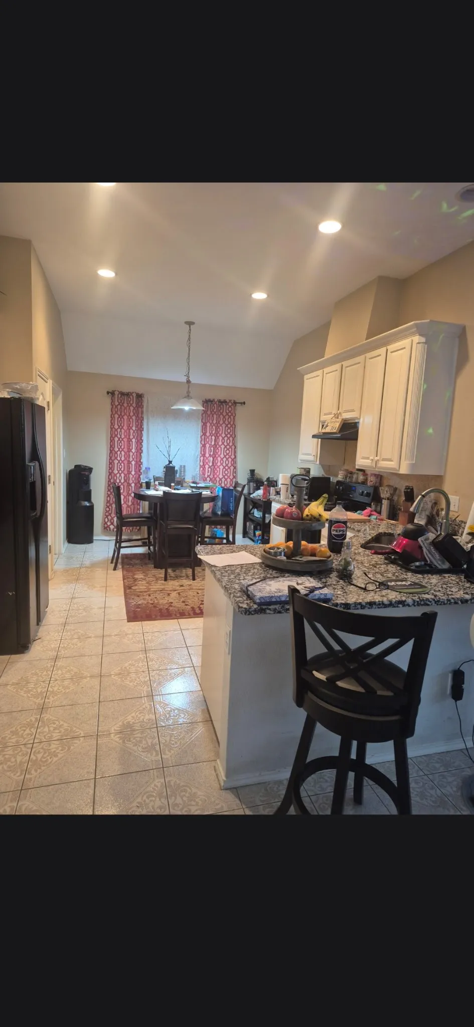 Kitchen featuring light-toned cabinetry, a granite-finish countertop, and tile flooring