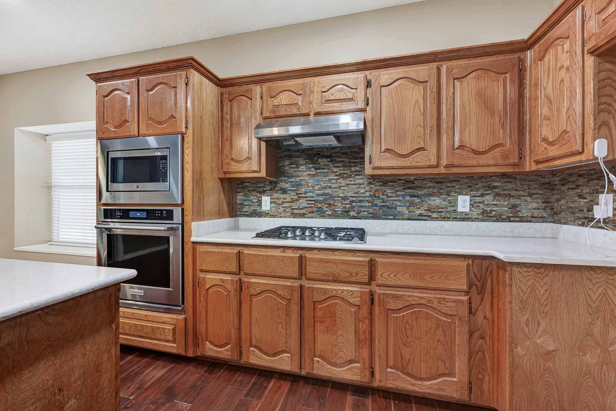 Updated appliances & countertop and backsplash in this large kitchen with Island.