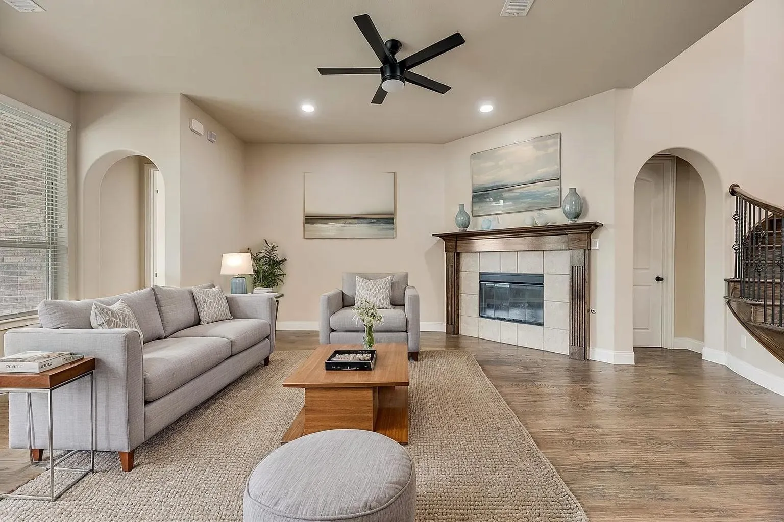 Wood-finish flooring throughout, complemented by recessed lighting and a ceiling fan