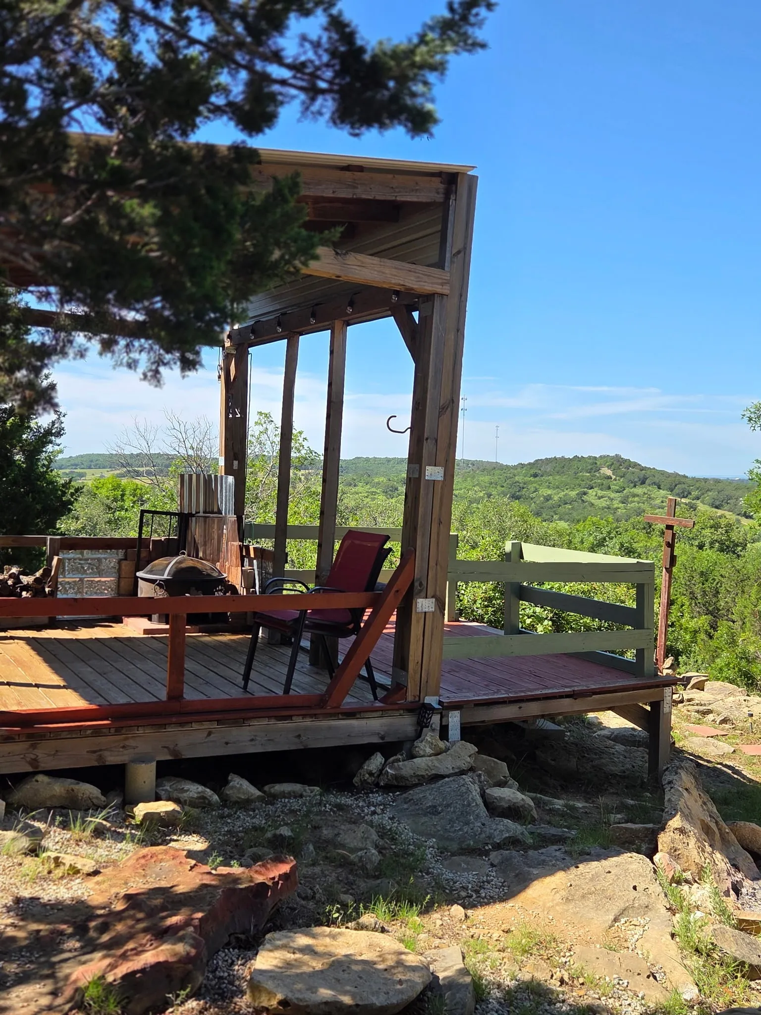 Elevated wood-decked patio with a partial pergola cover, offering expansive natural scenery