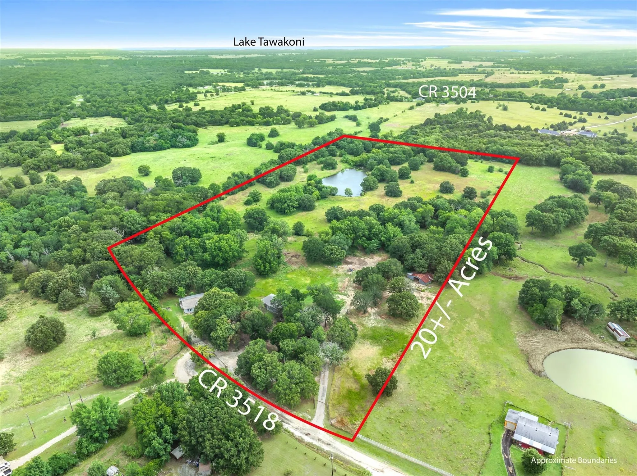 Expansive 20+ acre parcel featuring a private pond, abundant mature trees, open pastures, and direct access to CR 3518