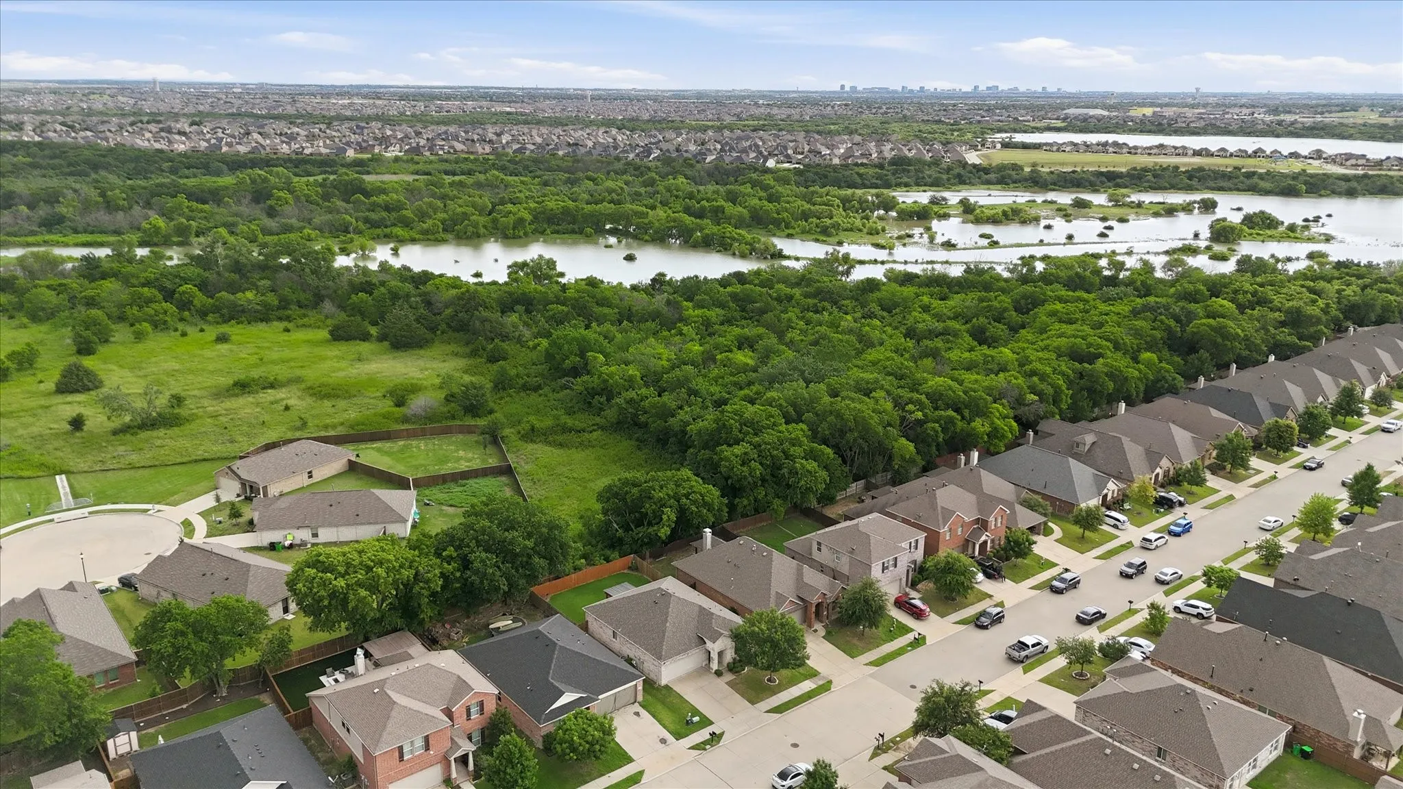 Residential area bordered by extensive green space and natural water features