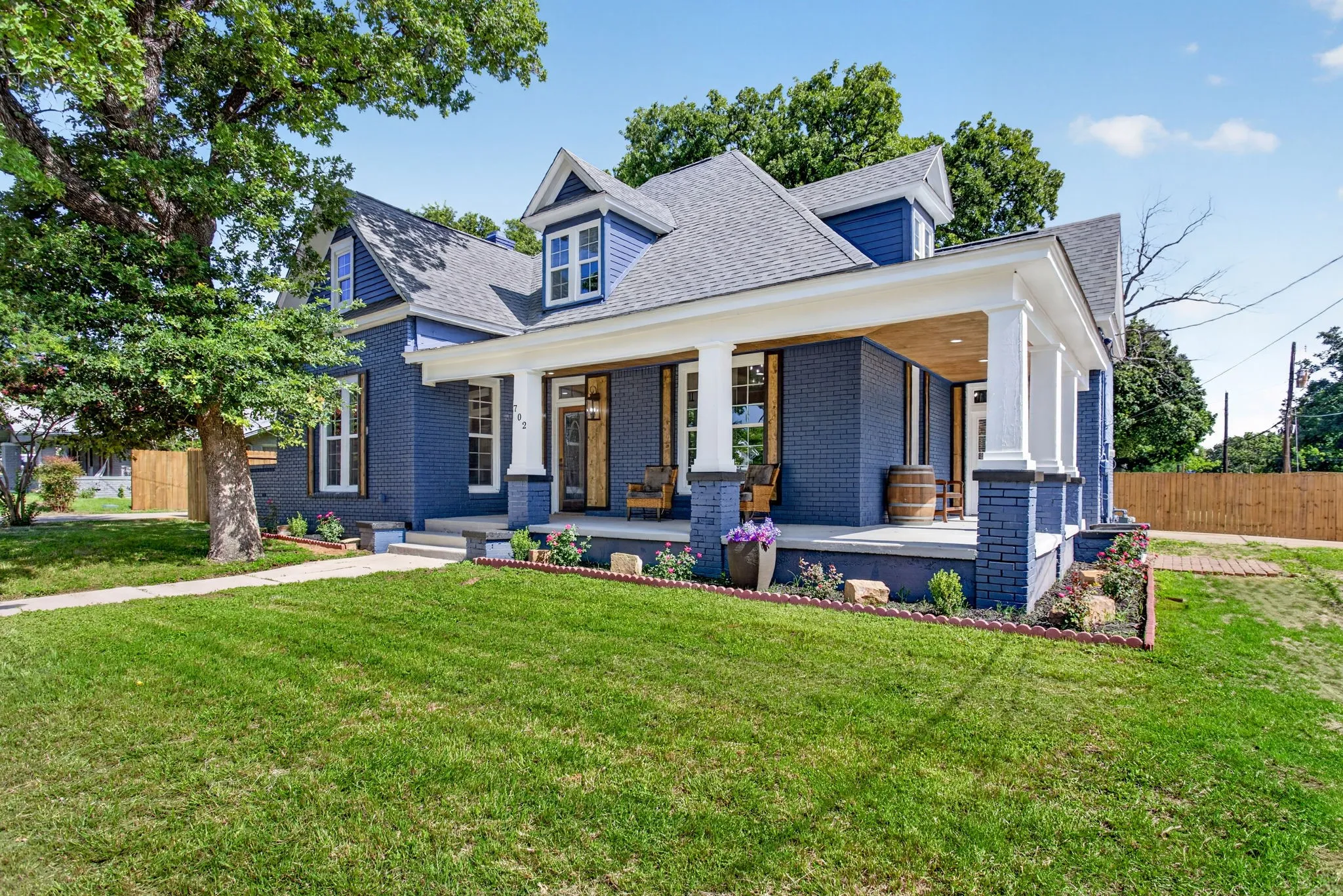 Exterior featuring blue brick siding and white trim accents