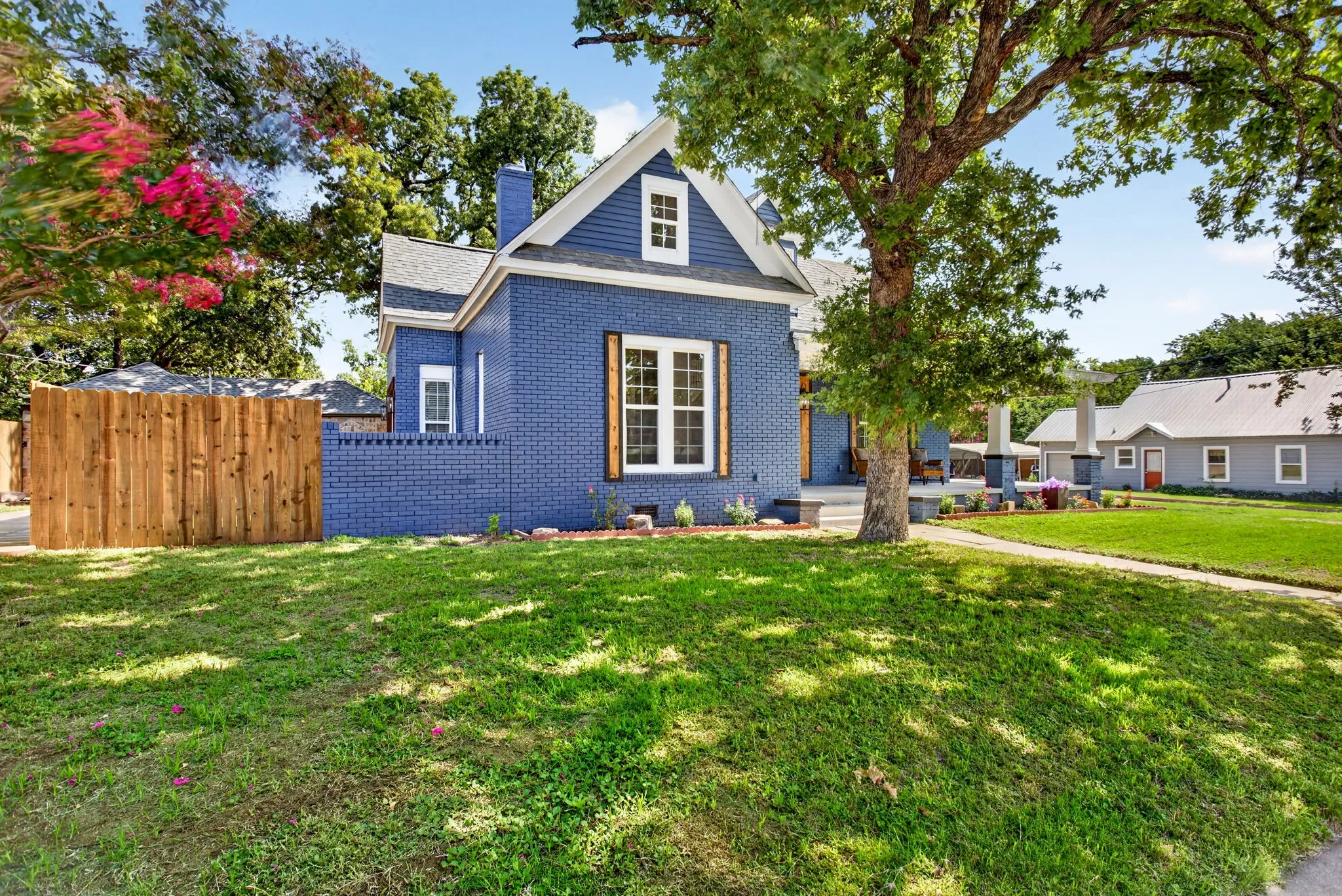 Cobalt blue brick exterior with white trim and a prominent gable