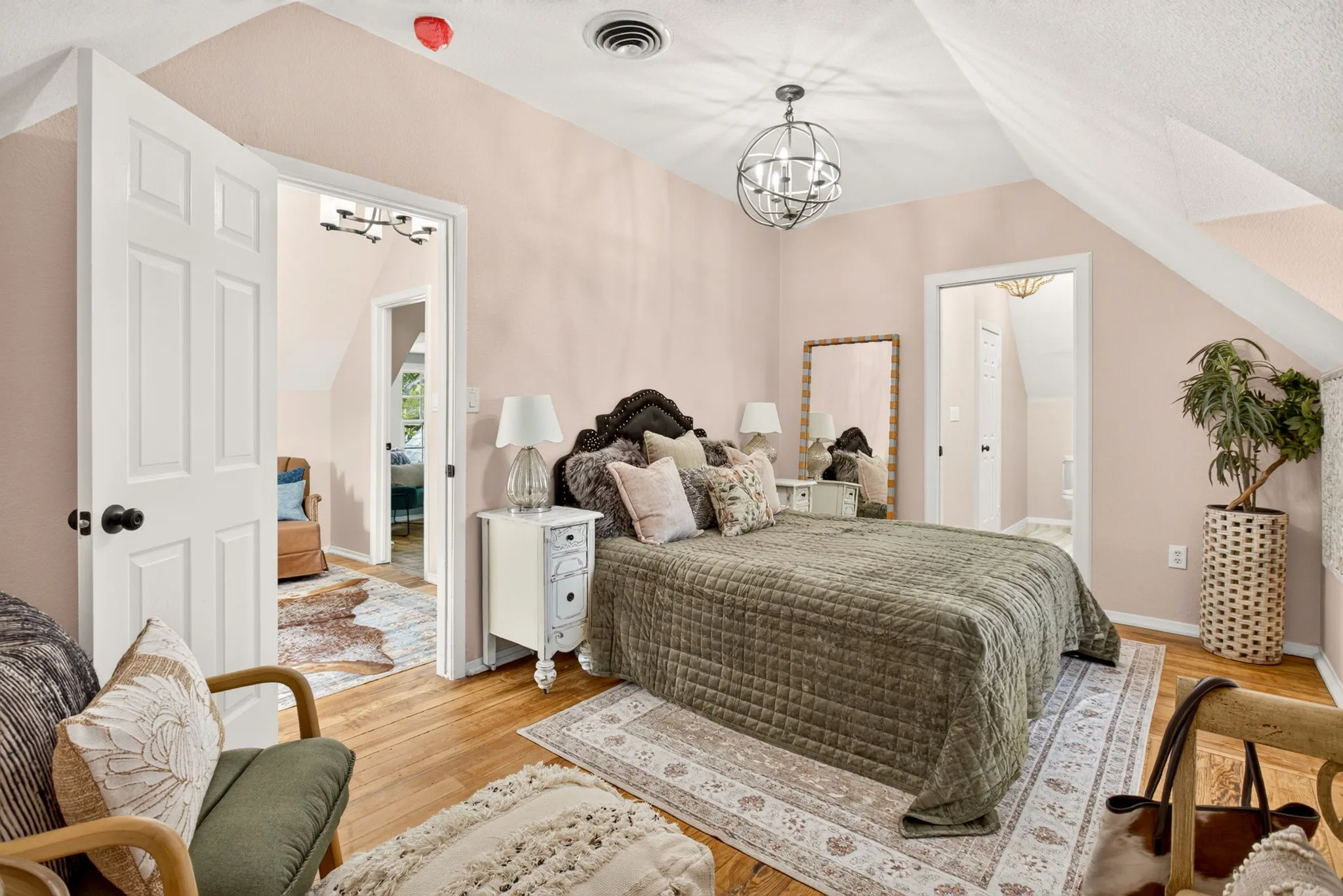 Bedroom featuring hardwood flooring, sloped ceiling, and a contemporary spherical chandelier