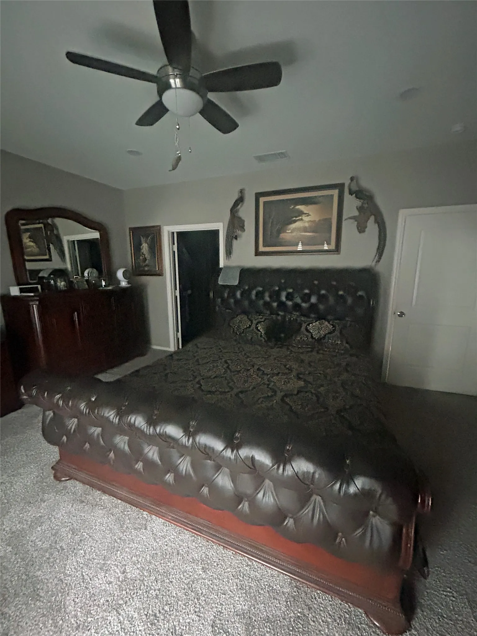 Carpeted room featuring a ceiling fan with integrated lighting, recessed ceiling lights, and two white doors