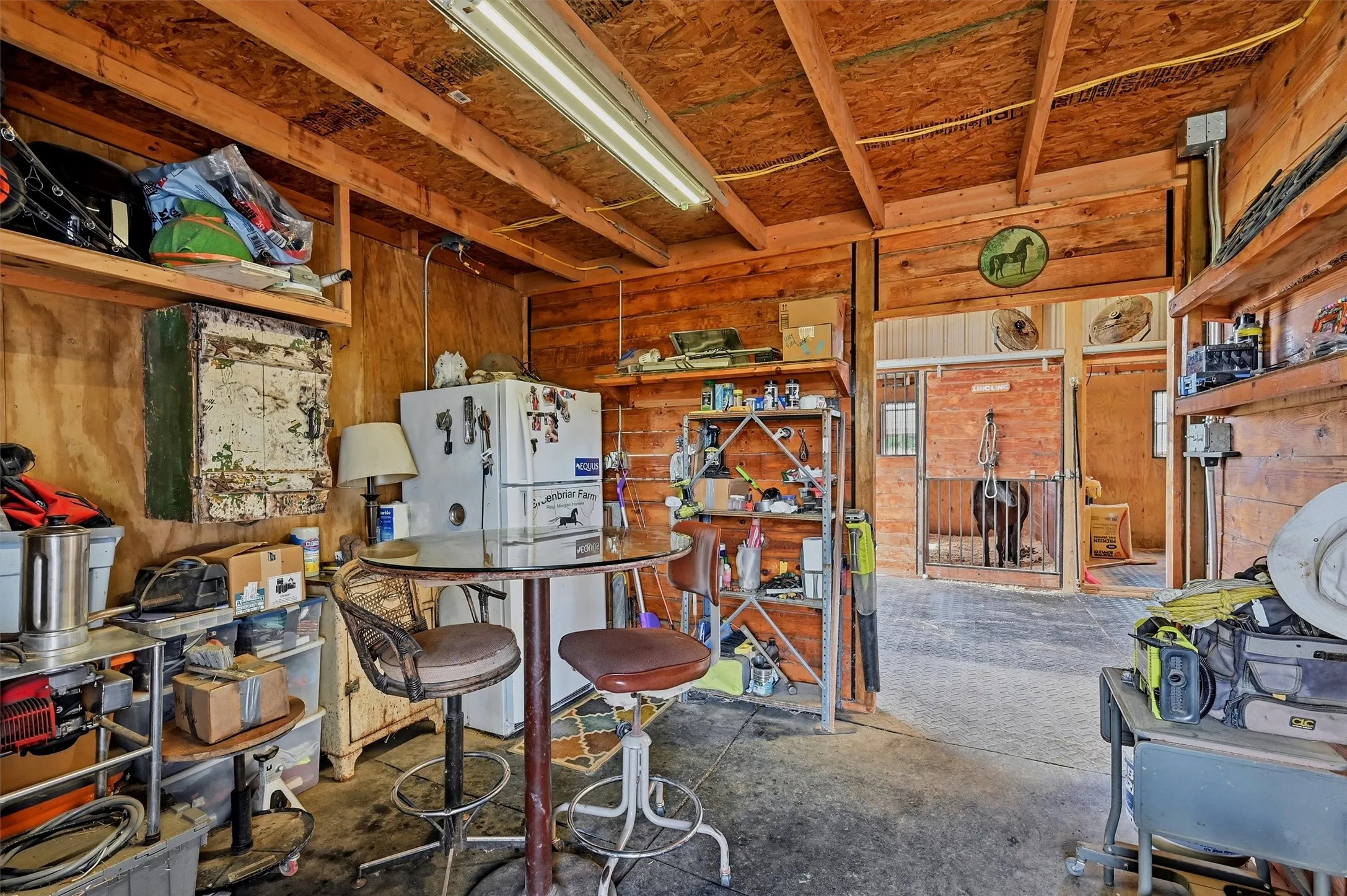 Wood-paneled interior space featuring exposed ceiling beams and structural supports